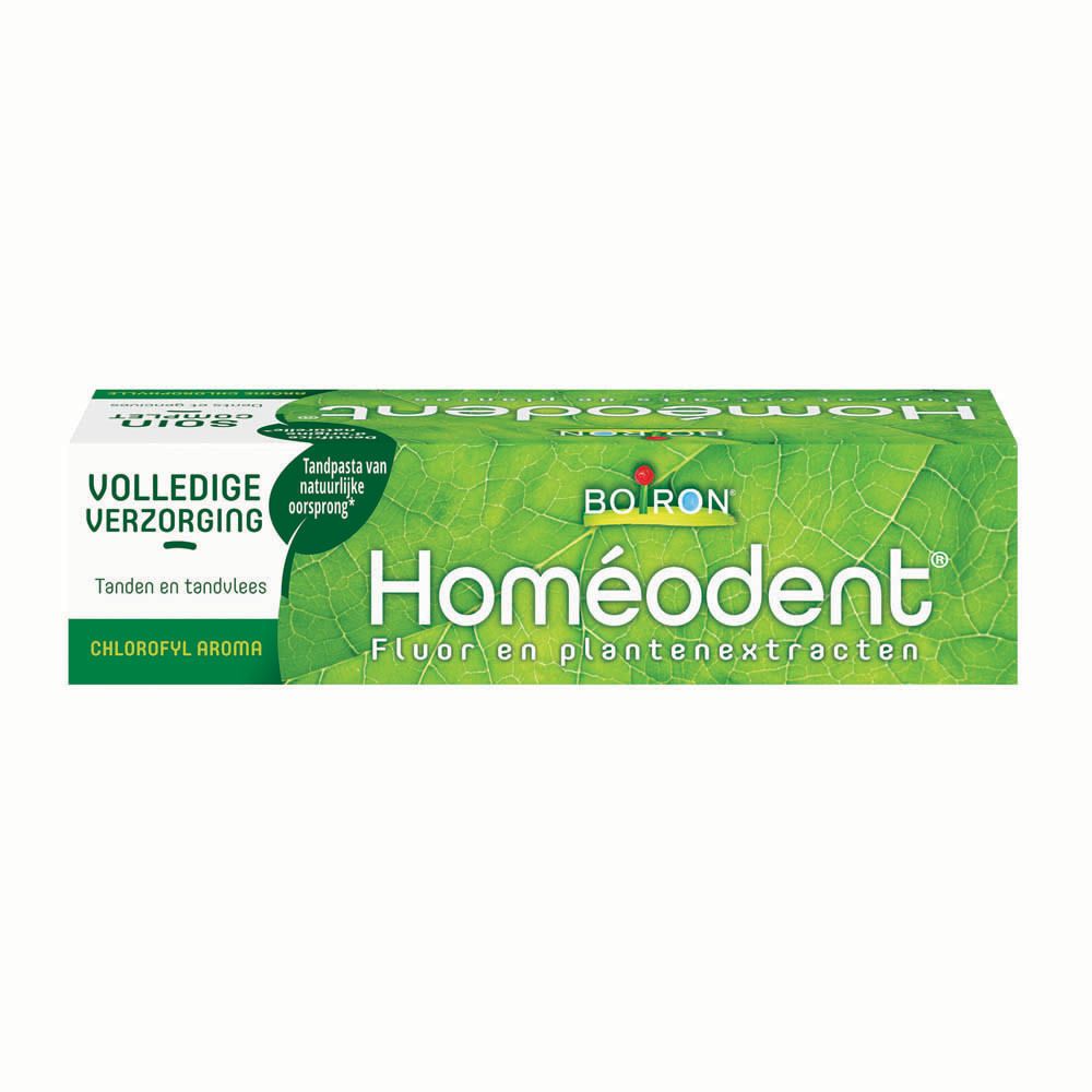 Homeodent Zahnpasta-Packung. Grün mit Blattmuster. Schriftzug Homeodent, Boiron. Fluor und Pflanzenextrakte.