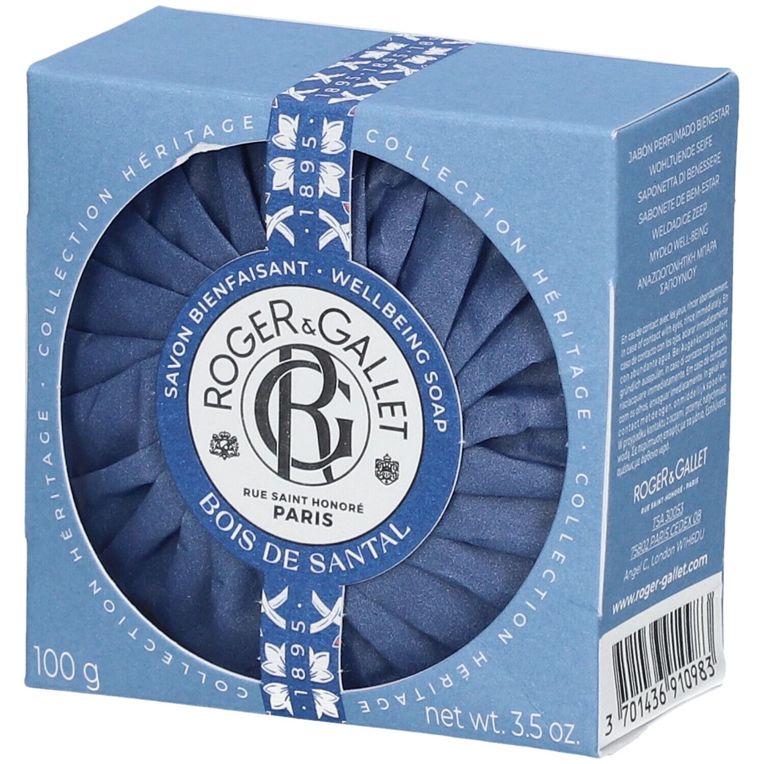 Blaue Seife in einer blauen Schachtel. Die Schachtel hat ein rundes Fenster, durch das die Seife sichtbar ist. Auf der Verpackung steht "Roger & Gallet".