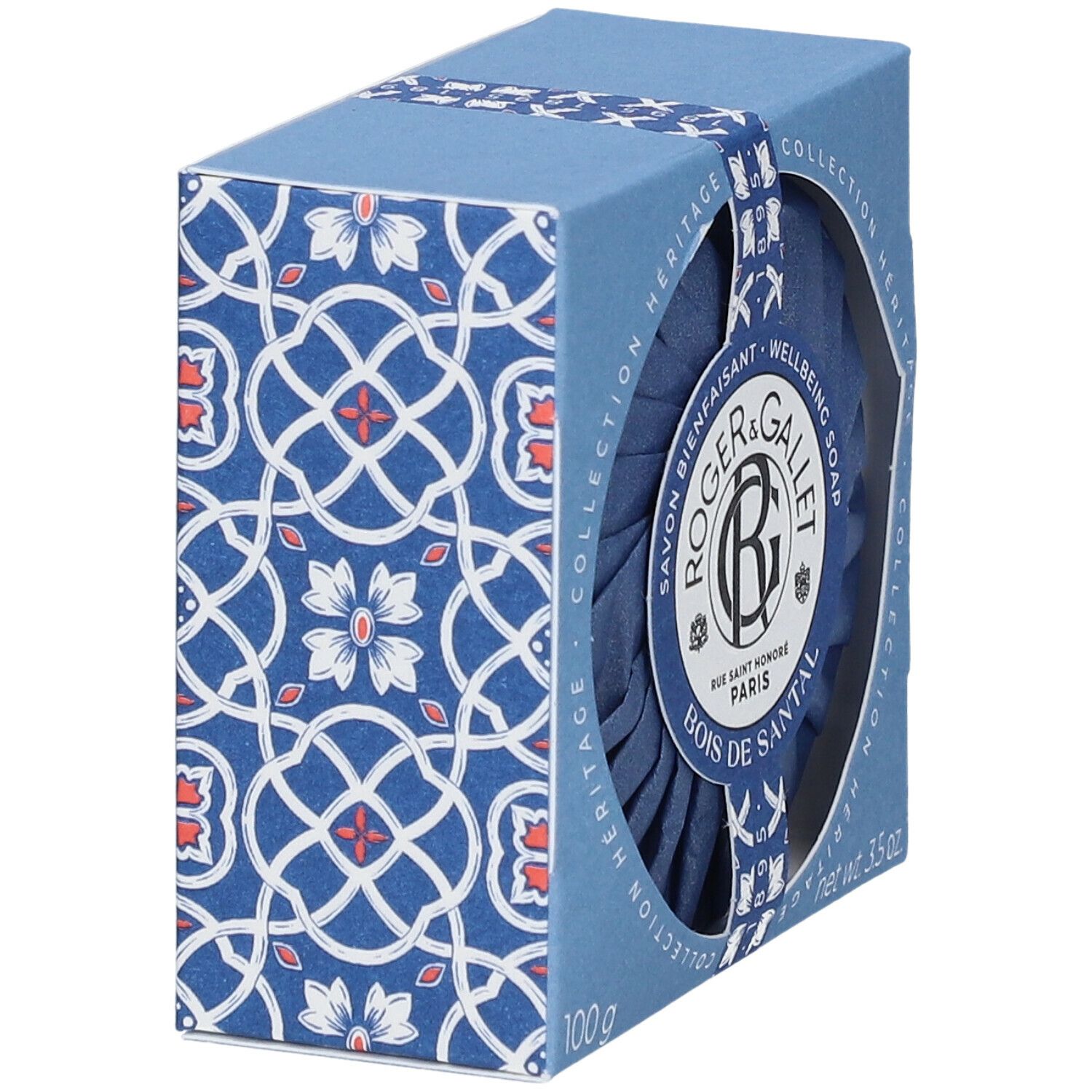 Blaue Seife in einer blauen Schachtel mit Muster. Die Schachtel hat ein rundes Fenster, durch das die Seife sichtbar ist. Auf der Verpackung steht "Roger & Gallet".