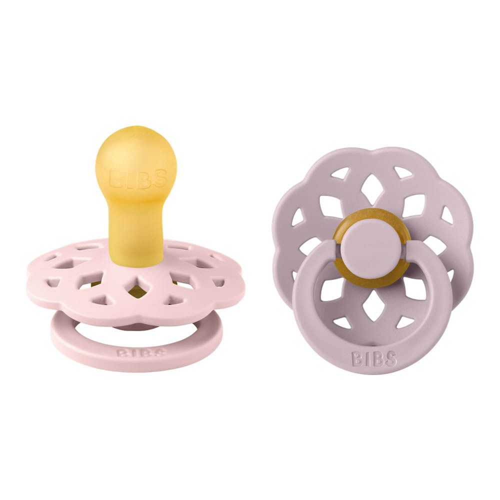 Deux sucettes roses et lilas avec tétines jaunes. Forme ronde, logo BIBS. Motif floral.