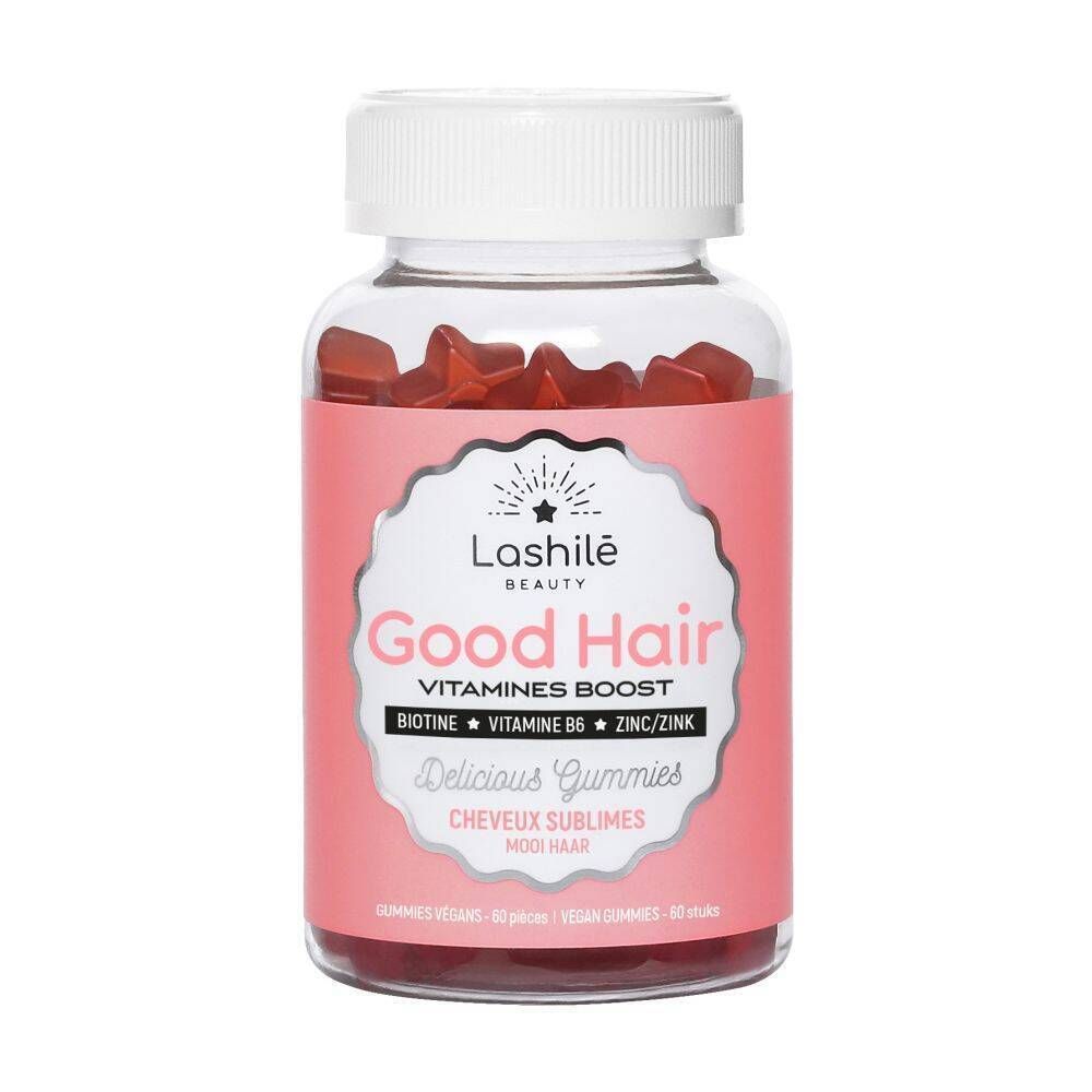 Flacon de gummies rouges. Étiquette "Good Hair" et ingrédients. Bouchon blanc. Fond rose.