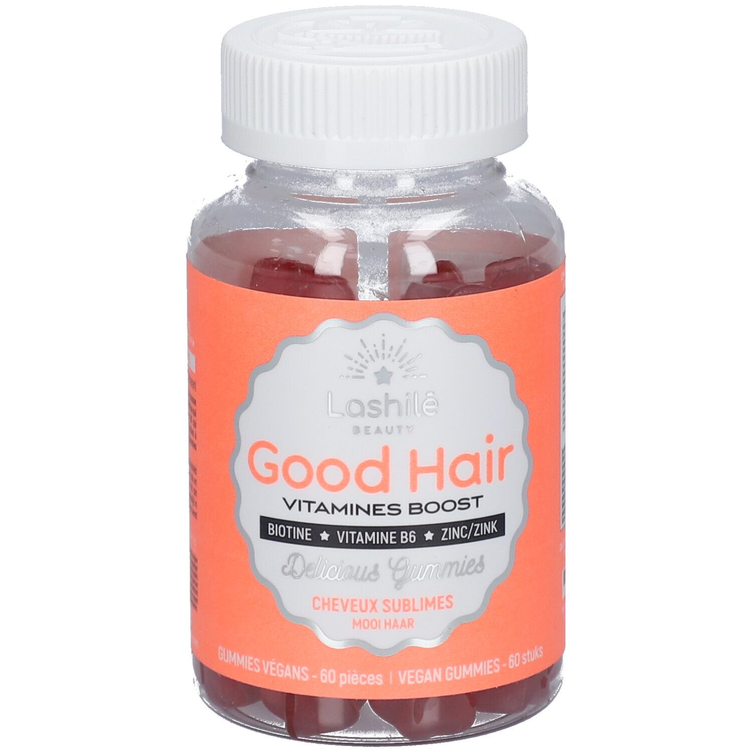 Flacon transparent de gummies rouges. Étiquette "Good Hair" et ingrédients. Bouchon blanc.
