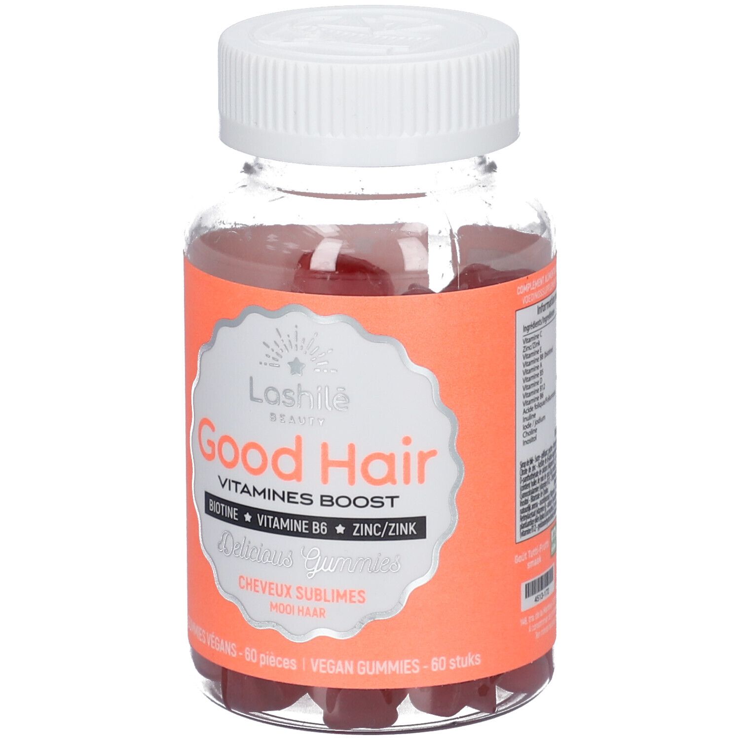 Flacon transparent de gummies rouges. Étiquette "Good Hair" et ingrédients. Bouchon blanc.