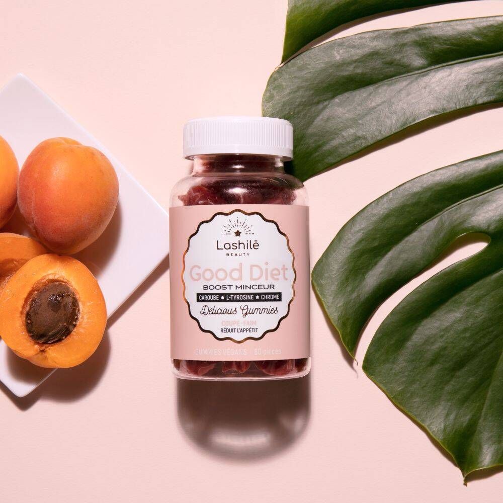 Flacon de gummies, abricots et feuilles. Texte: Good Diet. Fond rose.
