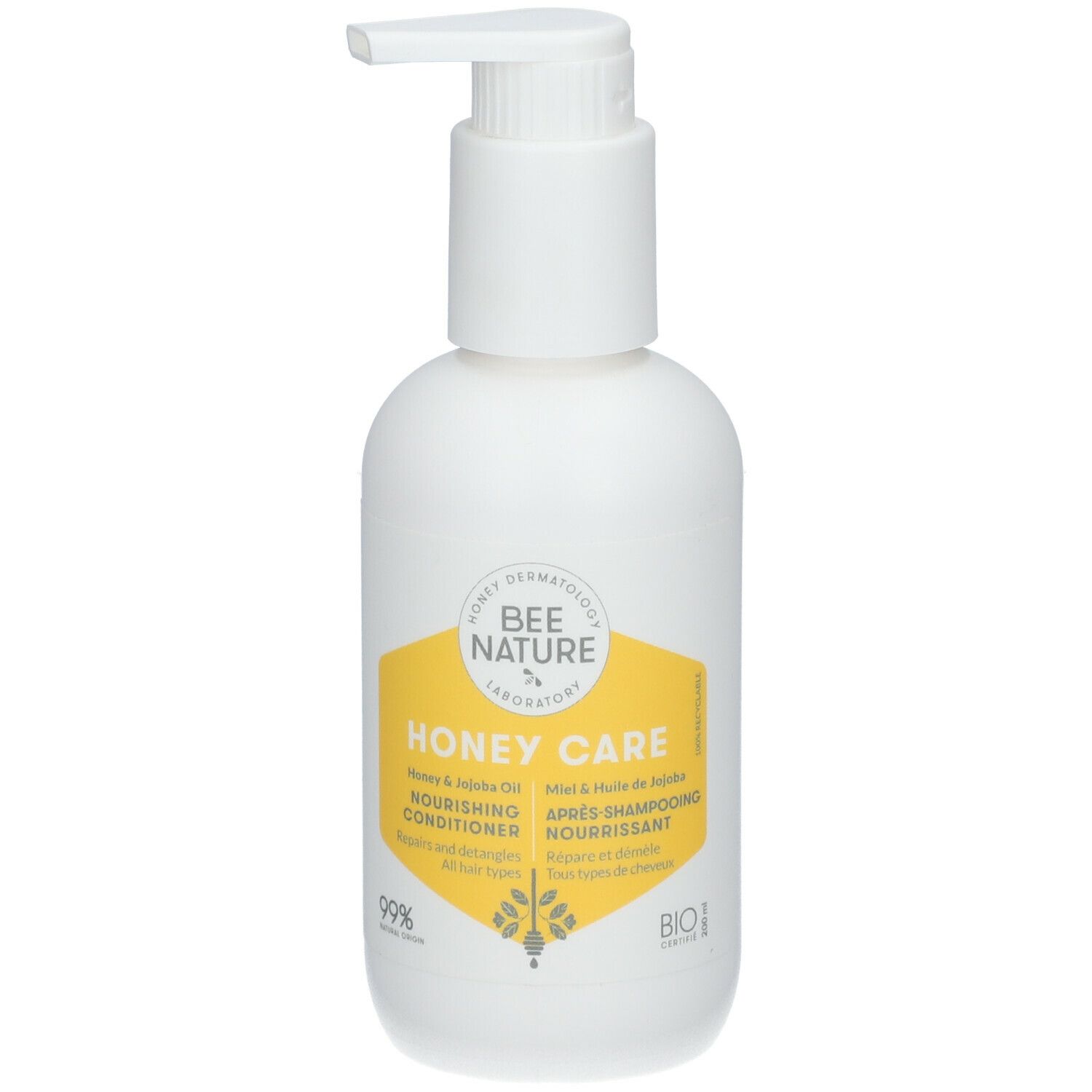 Flacon blanc avec pompe. Étiquette jaune avec texte: Honey Care, Nourishing Conditioner, Après-shampooing nourrissant.