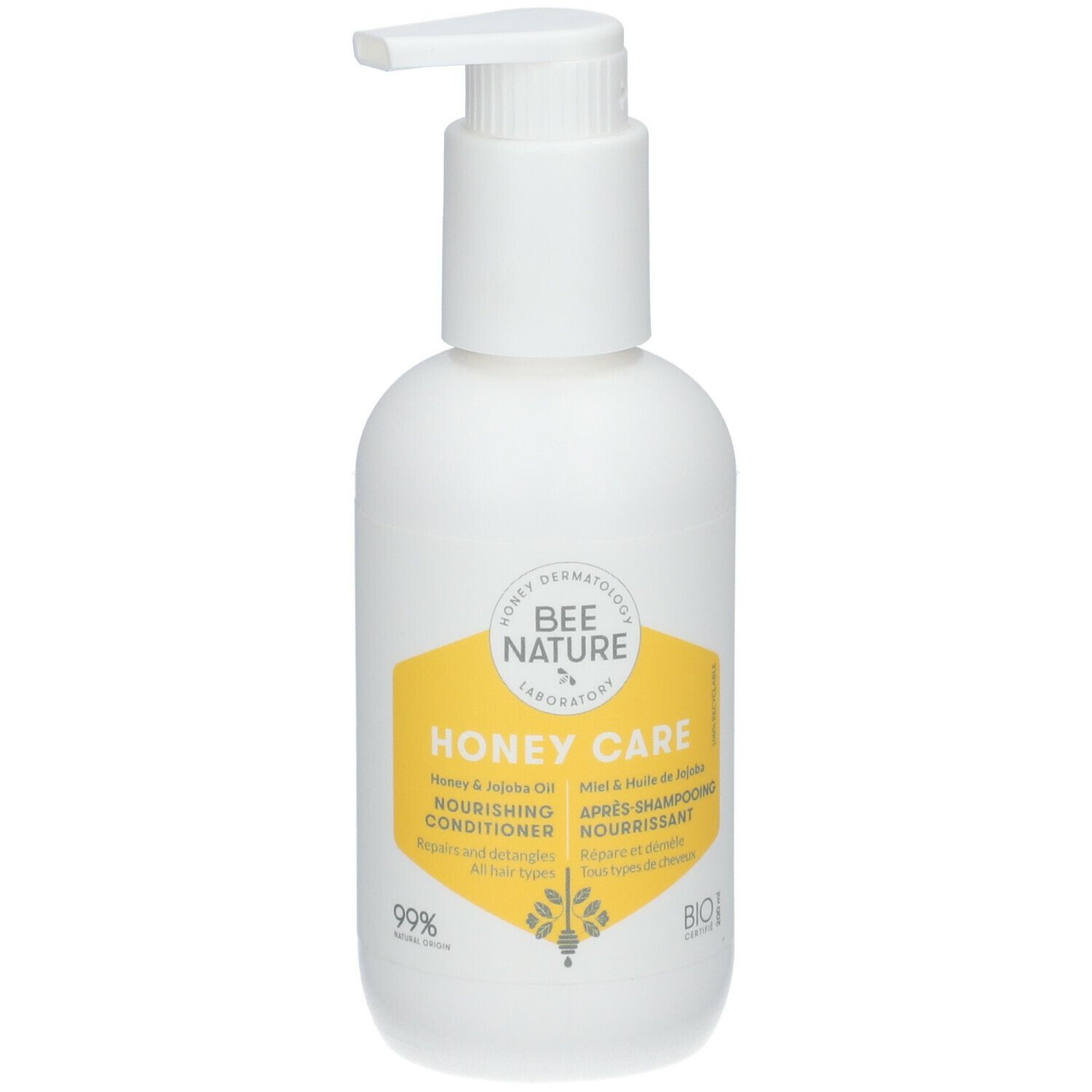 Flacon blanc avec pompe. Étiquette jaune avec texte: Honey Care, Nourishing Conditioner, Après-shampooing nourrissant.