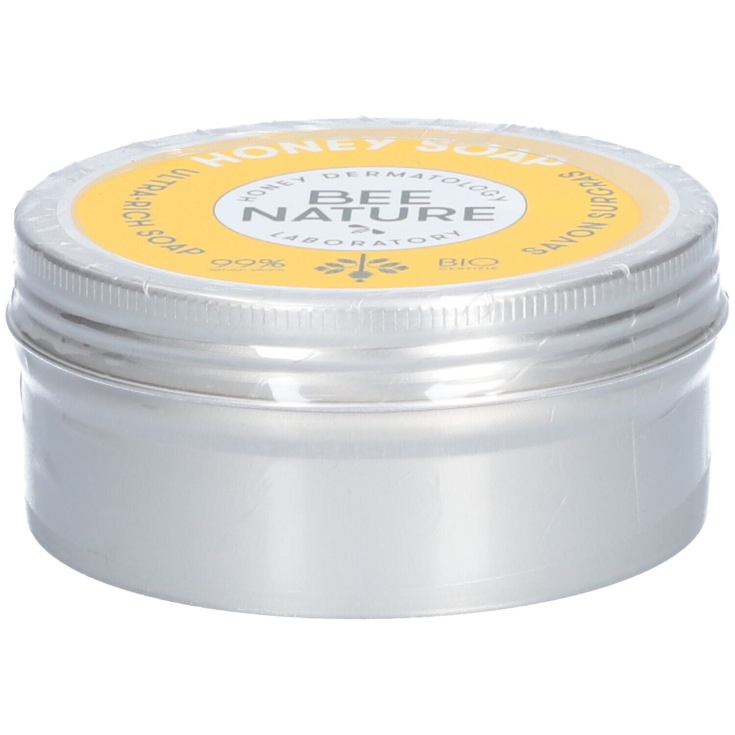 Ronde zilveren doos met gele deksel. Op de deksel staat "Honey Soap" en "Bee Nature".