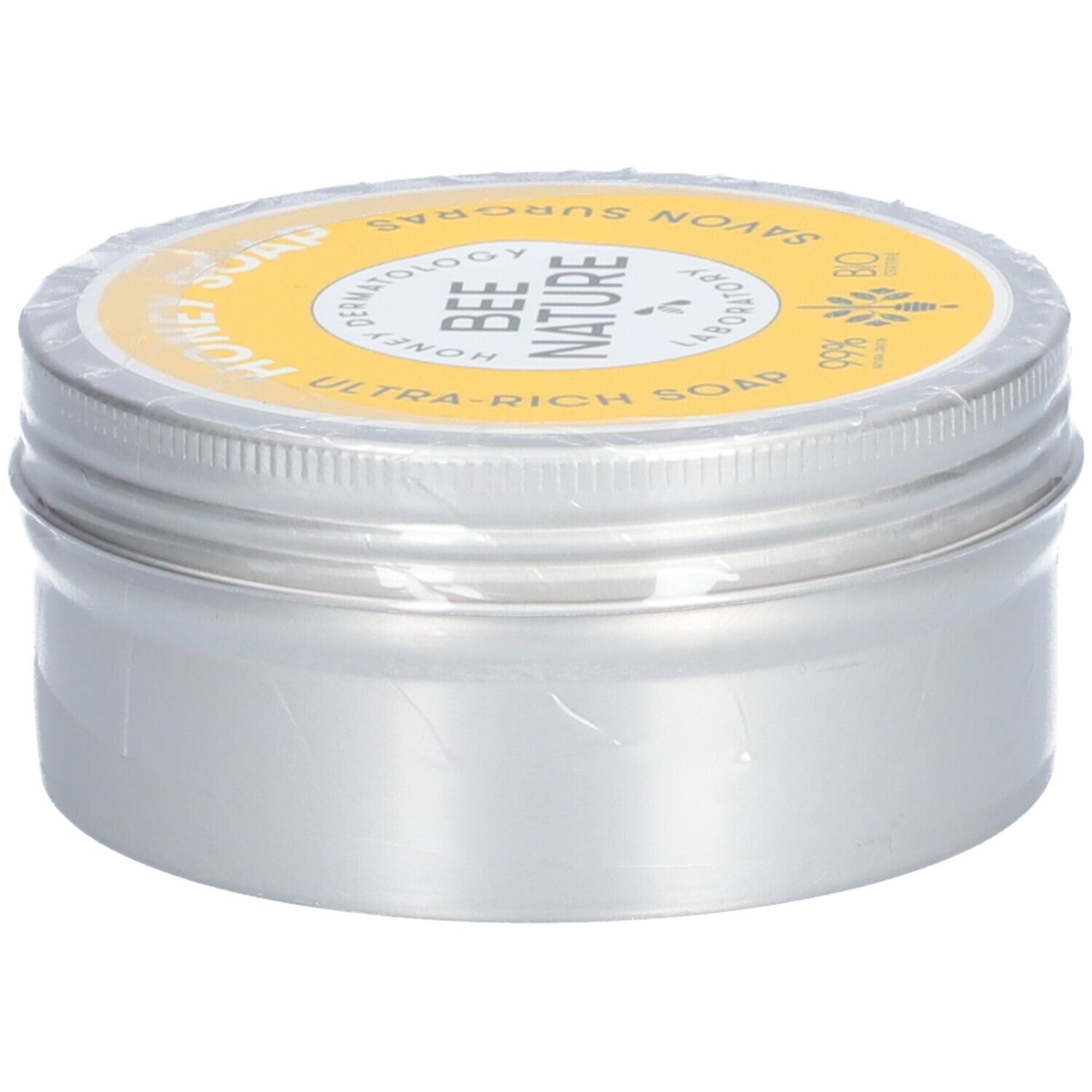 Ronde zilveren doos met gele deksel. Op de deksel staat "Honey Soap" en "Bee Nature".