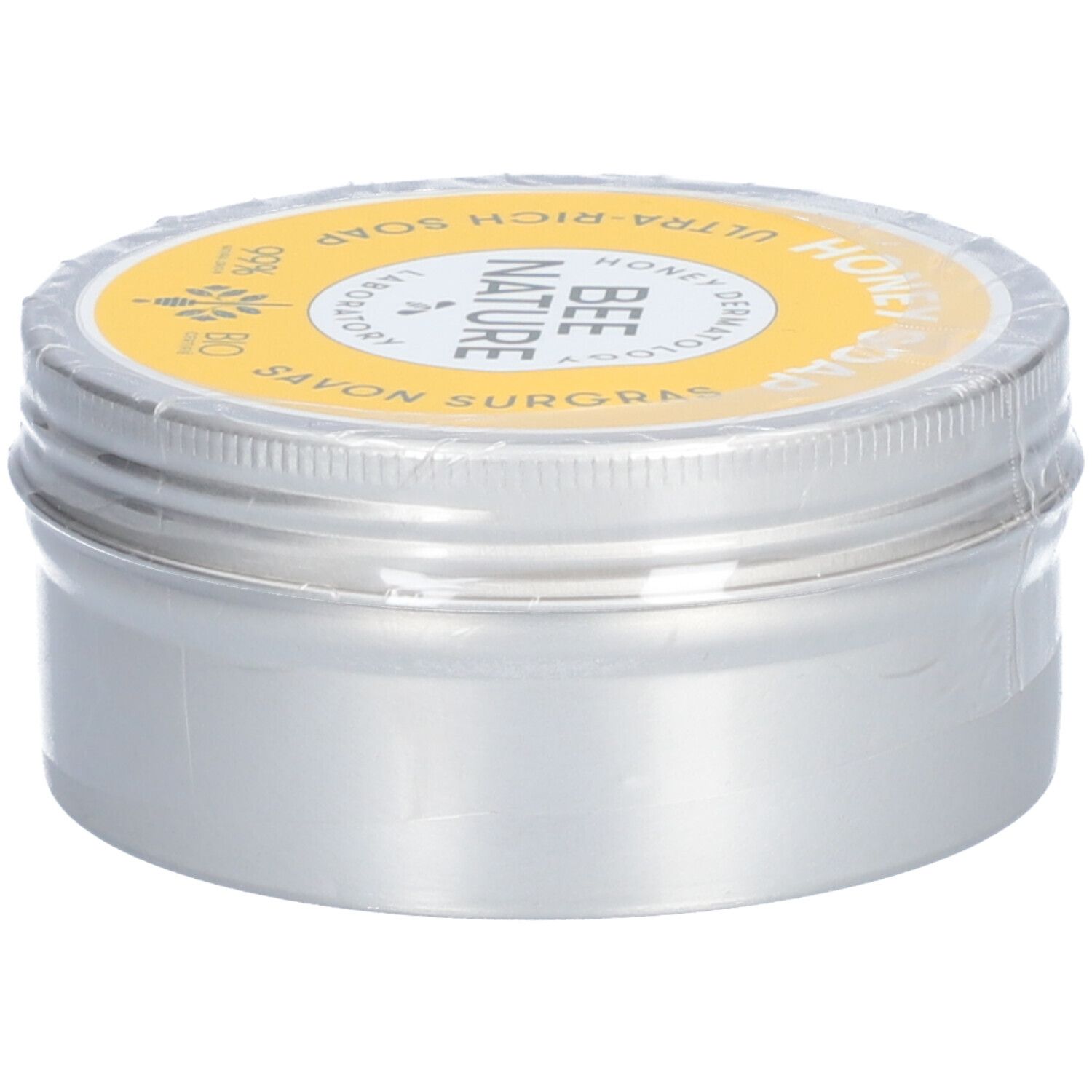 Ronde zilveren doos met gele deksel. Op de deksel staat "Honey Soap" en "Bee Nature".