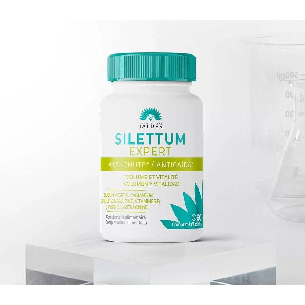 Flacon blanc à bouchon vert. Inscription: Silettum Expert Anti-Chute. Contient 60 comprimés. Ingrédients: Silicium vegetal, Zinc, Vitamines B.