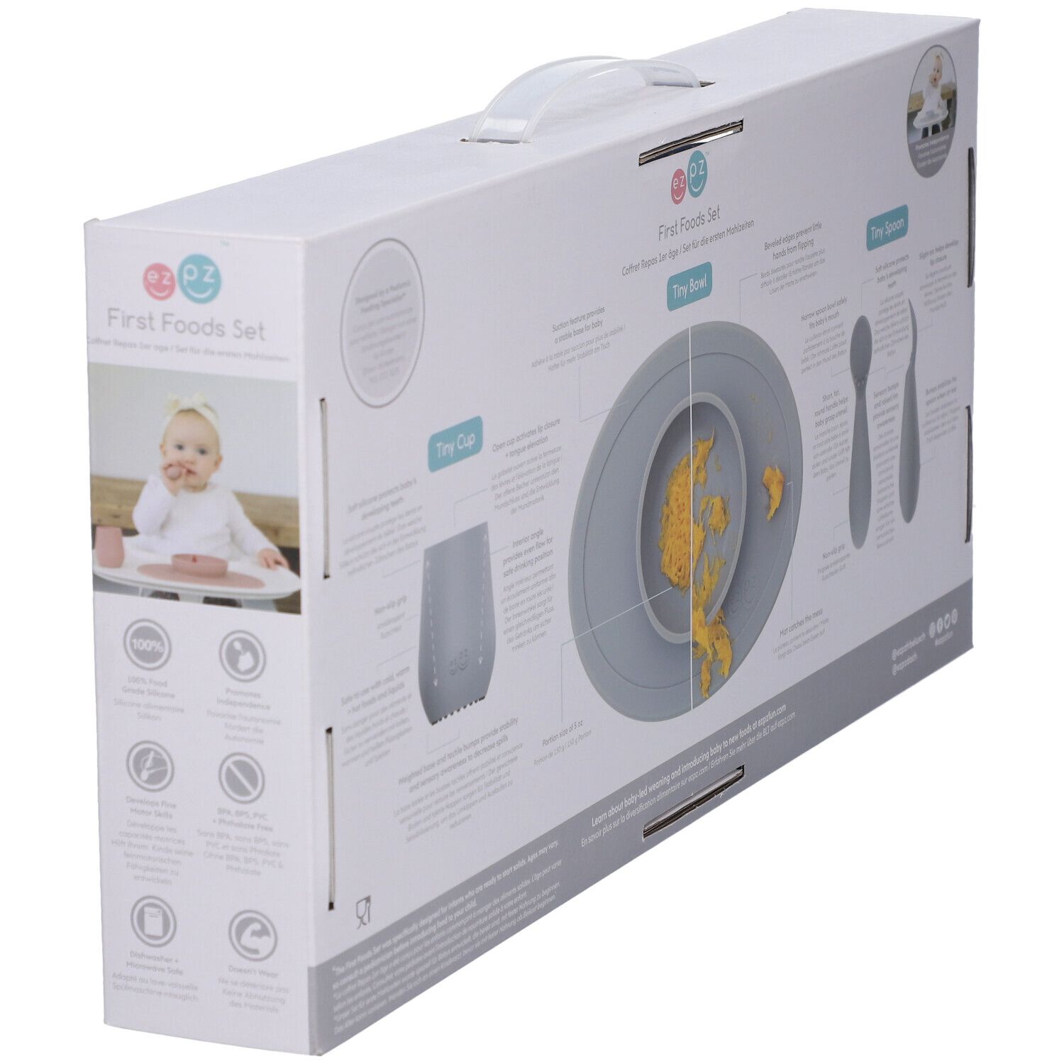 Verpackung für ein 'First Foods Set' mit Teller, Becher und Besteck für Babys. Enthält Abbildungen von Baby und Produkten.