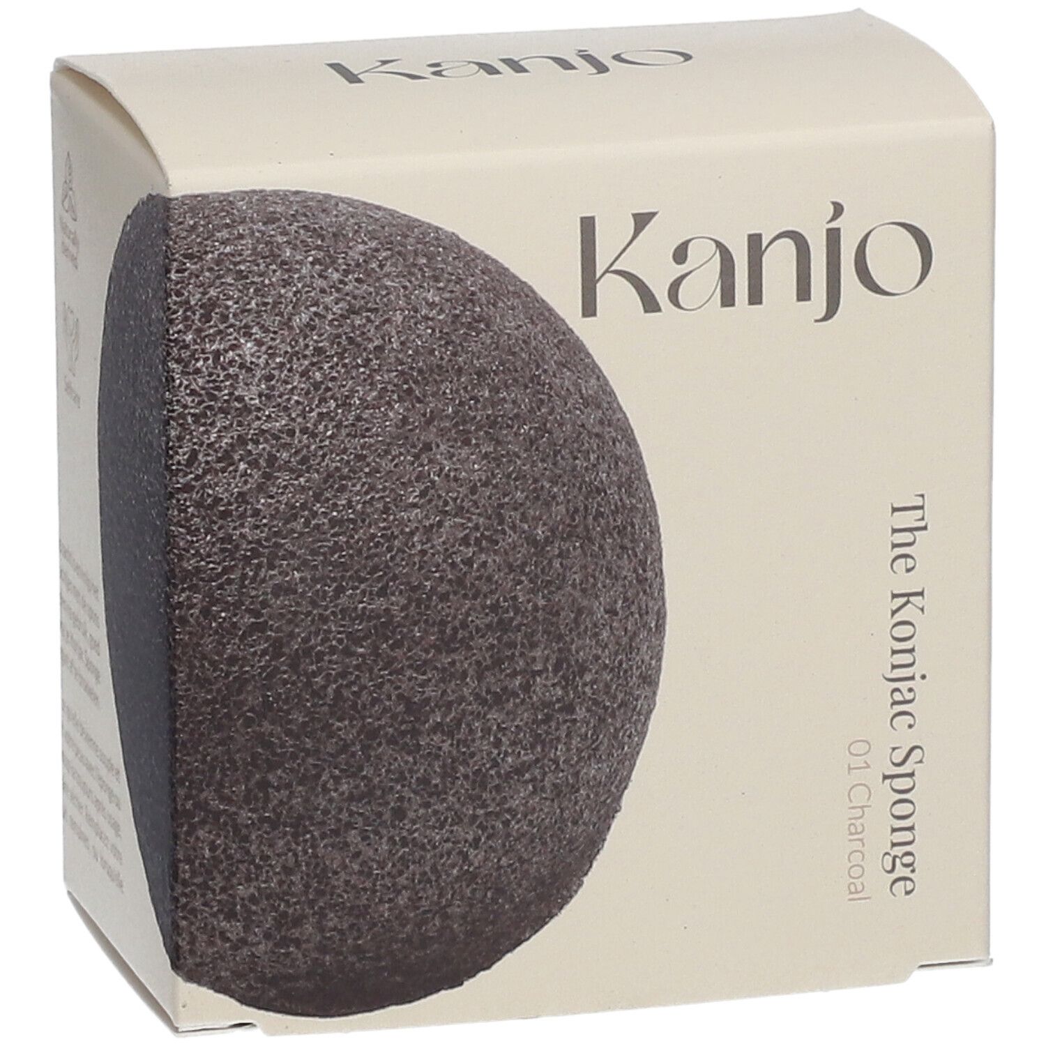 Kartonverpackung mit Konjac-Schwamm. Aufschrift: Kanjo, The Konjac Sponge 01 Charcoal. Schwamm halb sichtbar, dunkelgrau.