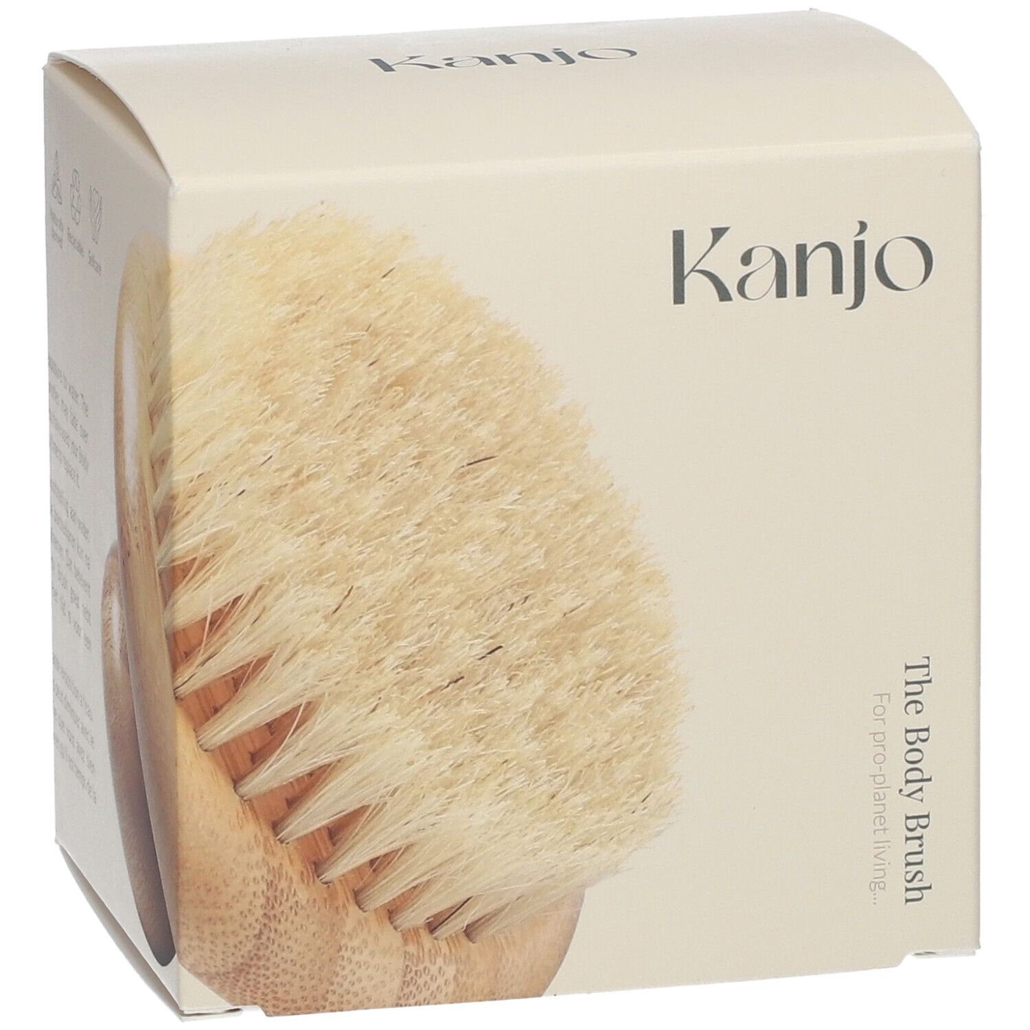 Brosse corporelle dans un emballage crème. Inscription "Kanjo" et "The Body Brush".