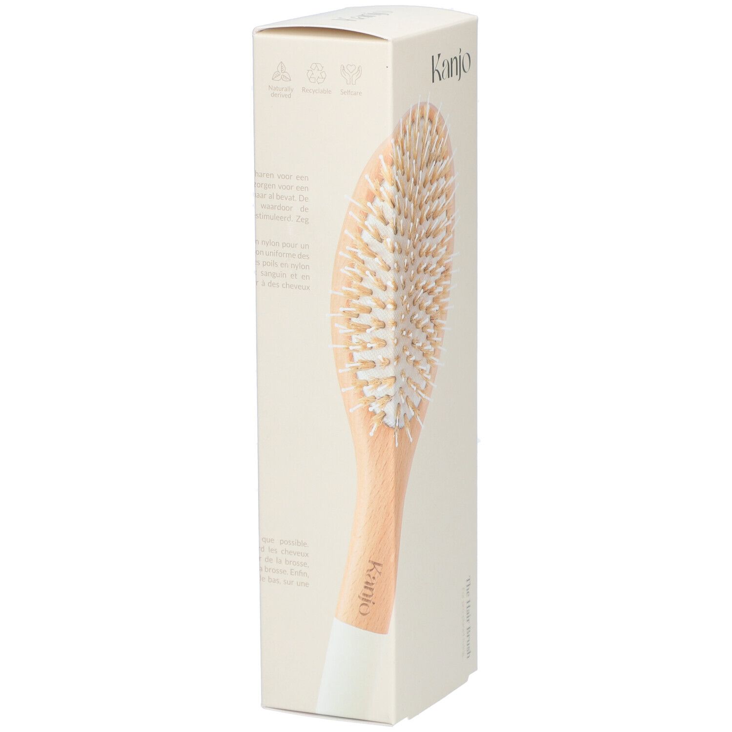 Kanjo Haarbürste in Verpackung. Holzgriff, helle Borsten. Aufschrift: Kanjo, The Hair Brush.