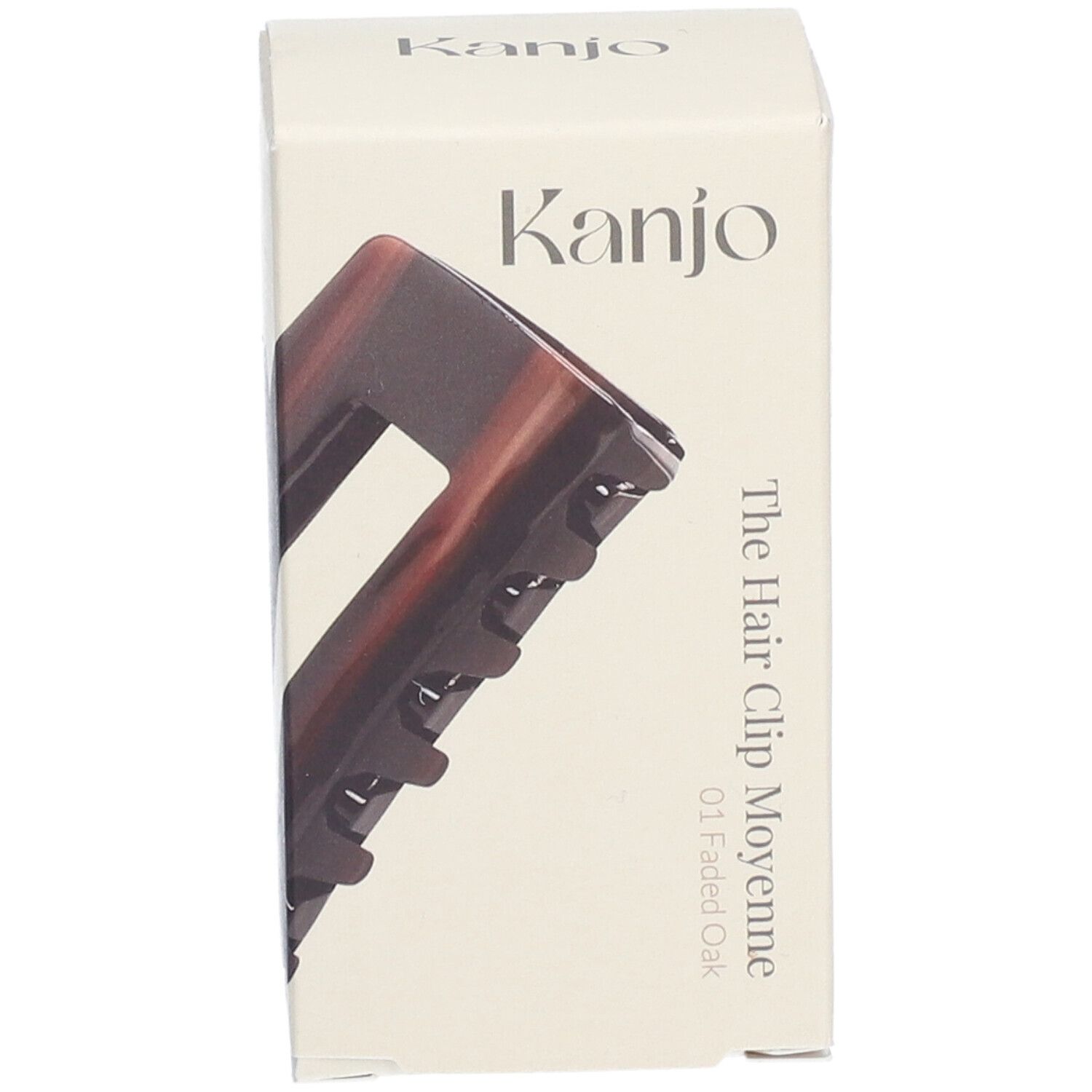 Haarspange in Verpackung. Marke: Kanjo. Aufschrift: The Hair Clip Moyenne 01 Faded Oak. Braun-transparente Farbe.