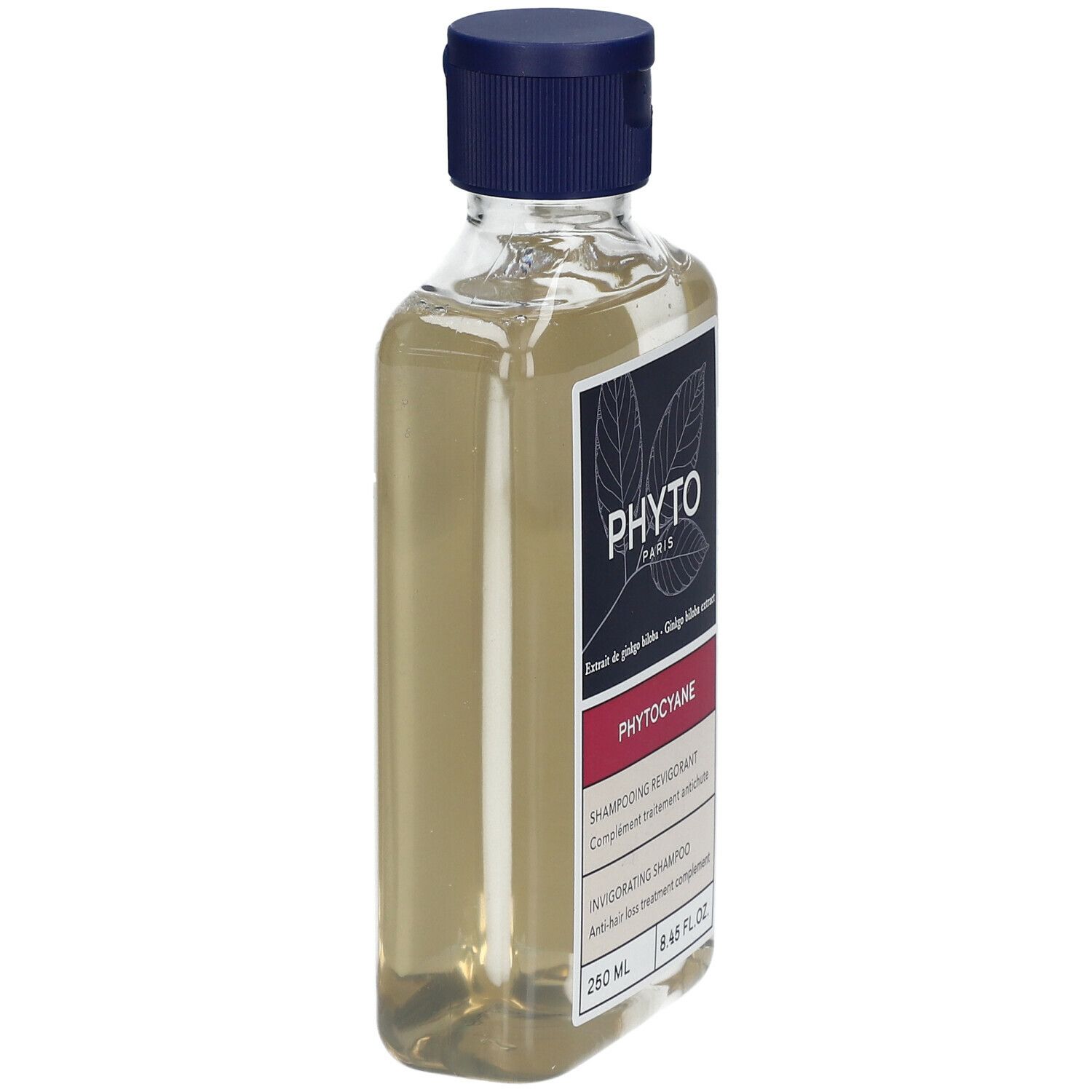 Flacon transparent, bouchon bleu. Étiquette "PHYTO PARIS", "PHYTOCYANE".