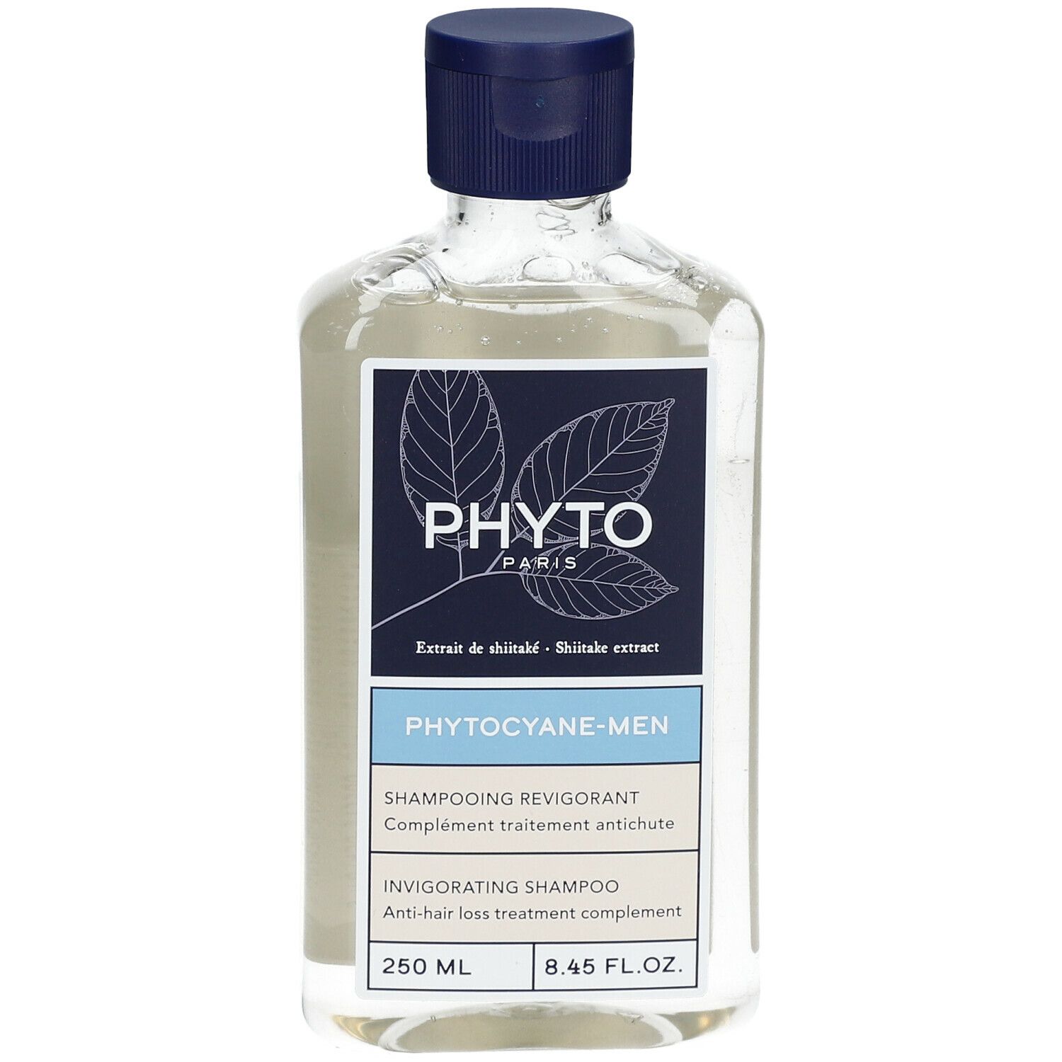 Flacon de shampooing transparent avec bouchon bleu. Étiquette avec nom de produit et marque.