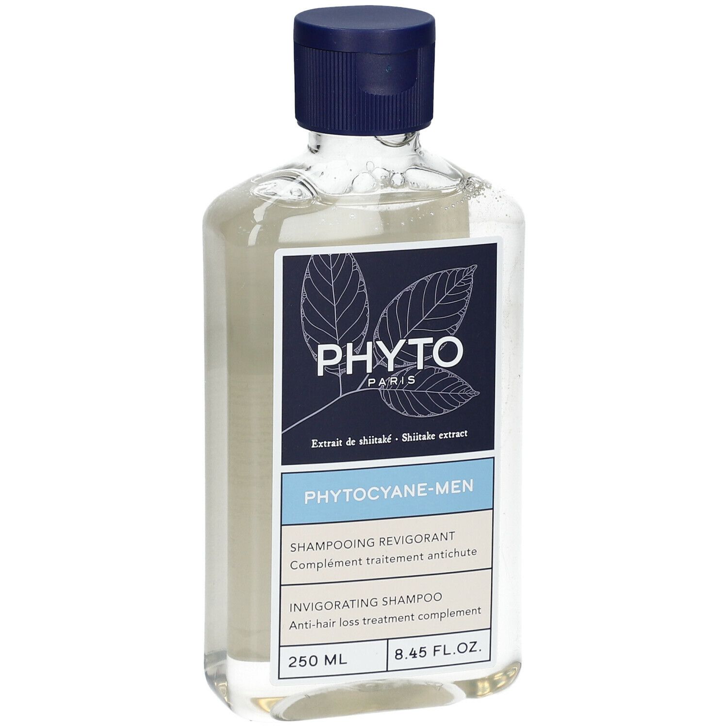 Flacon de shampooing transparent avec bouchon bleu. Étiquette avec nom de produit et marque.
