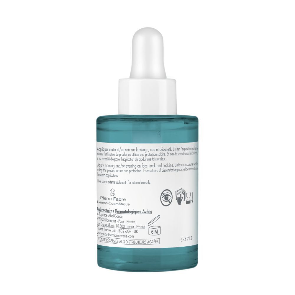 Achterkant van de blauwgroene fles met witte dop en pipet. Tekst en symbolen.