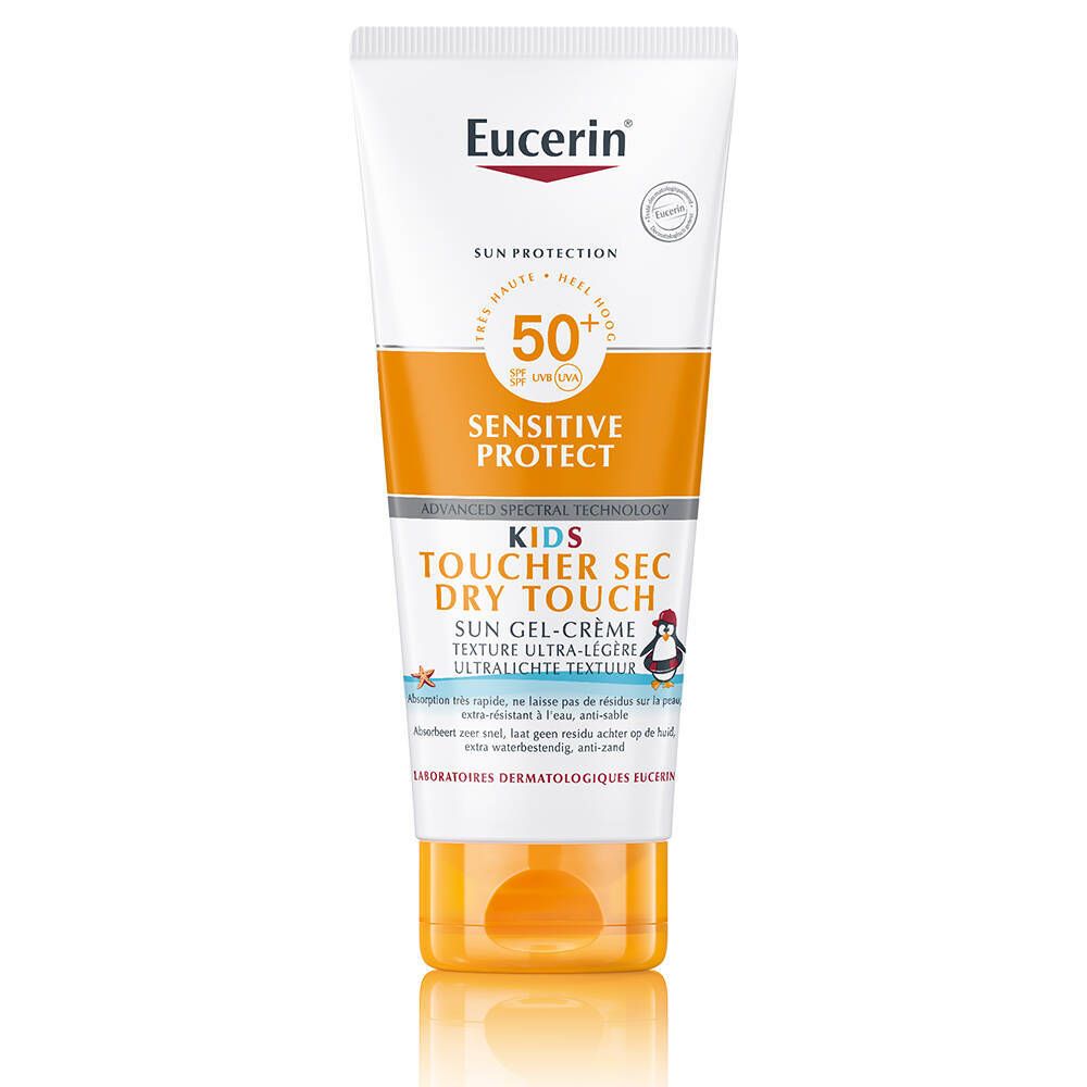 Tube blanche et orange de crème solaire. Texte : SPF 50+, Sensitive Protect, Kids, Dry Touch. Illustration de pingouin.