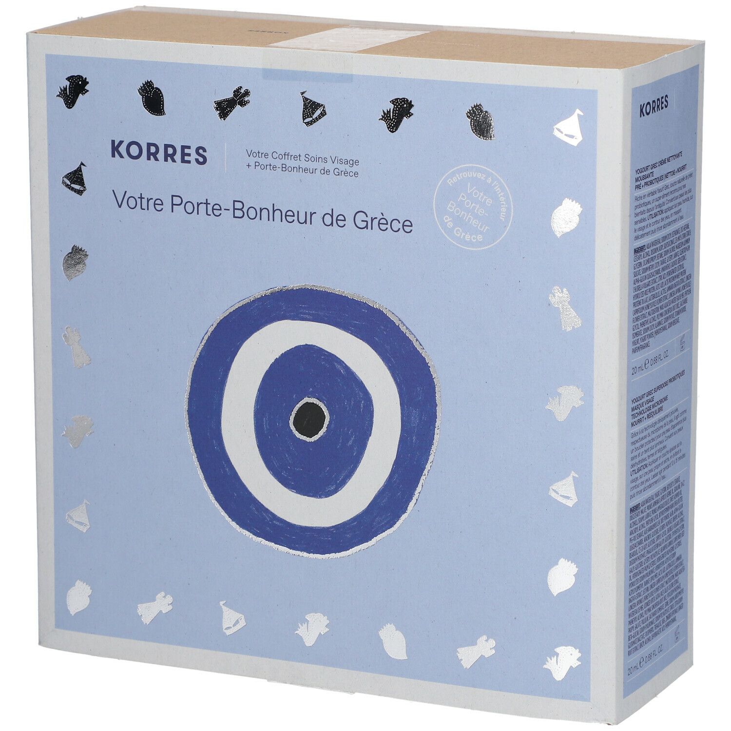 Kartonnen doos Korres met Grieks geluksbrenger-motief. Tekst: Votre Porte-Bonheur de Grèce.