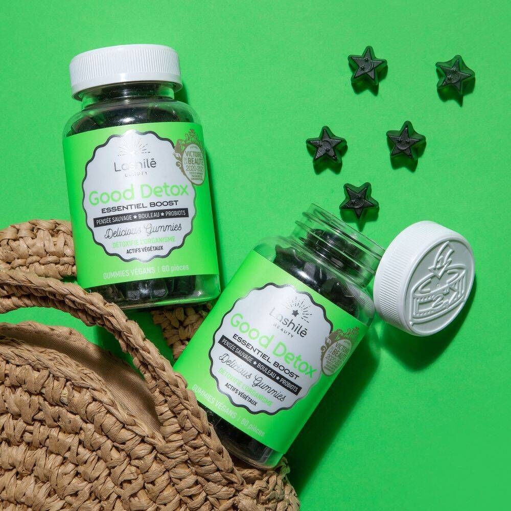 Deux flacons avec gummies. Gummies étoiles. Inscription : Good Detox, Essentiel Boost. Fond vert.