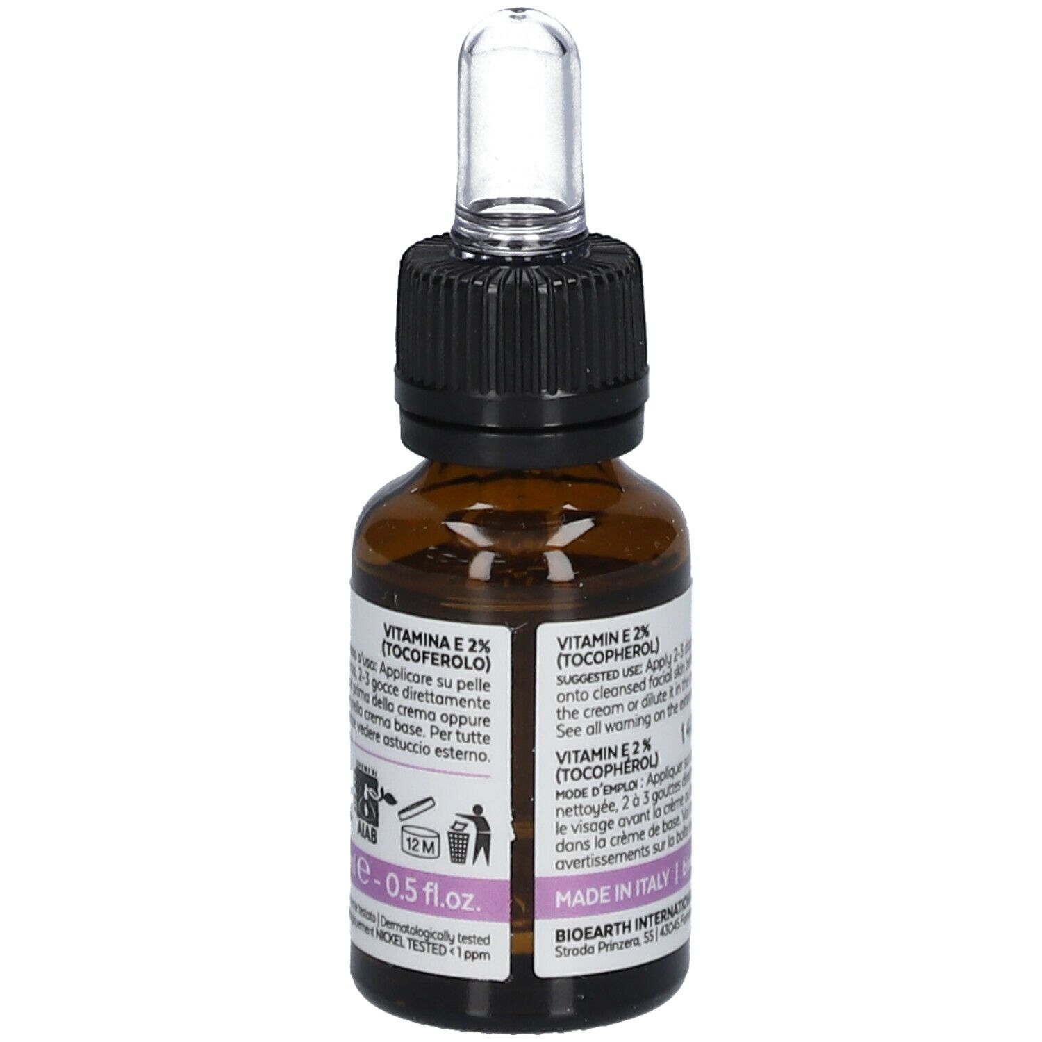 Bruine glazen fles met pipet. Label met tekst en "Vitamin E 2% (Tocoferolo)".