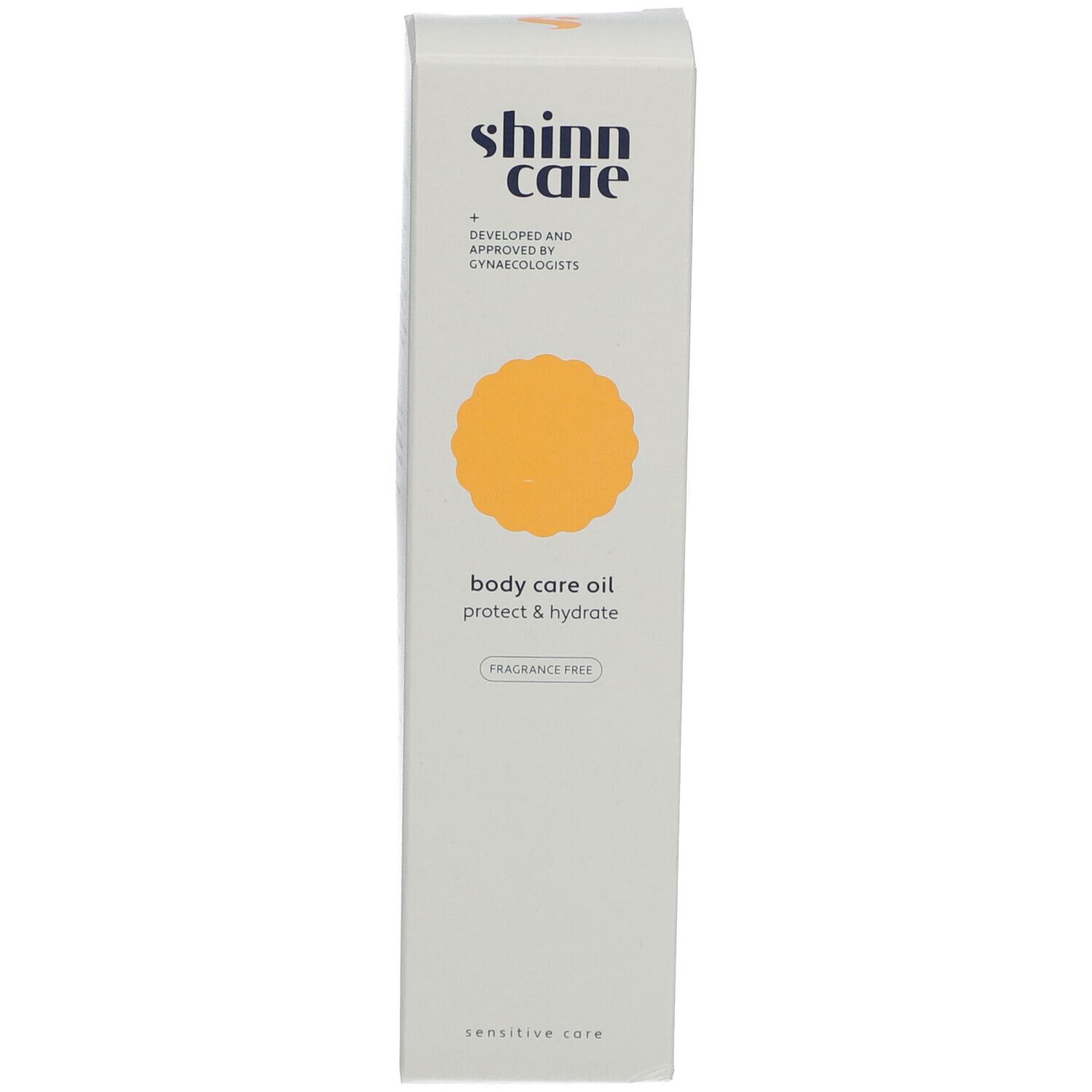 Hoher, schmaler Karton. Aufschrift: shinn care, body care oil, protect & hydrate, fragrance free.