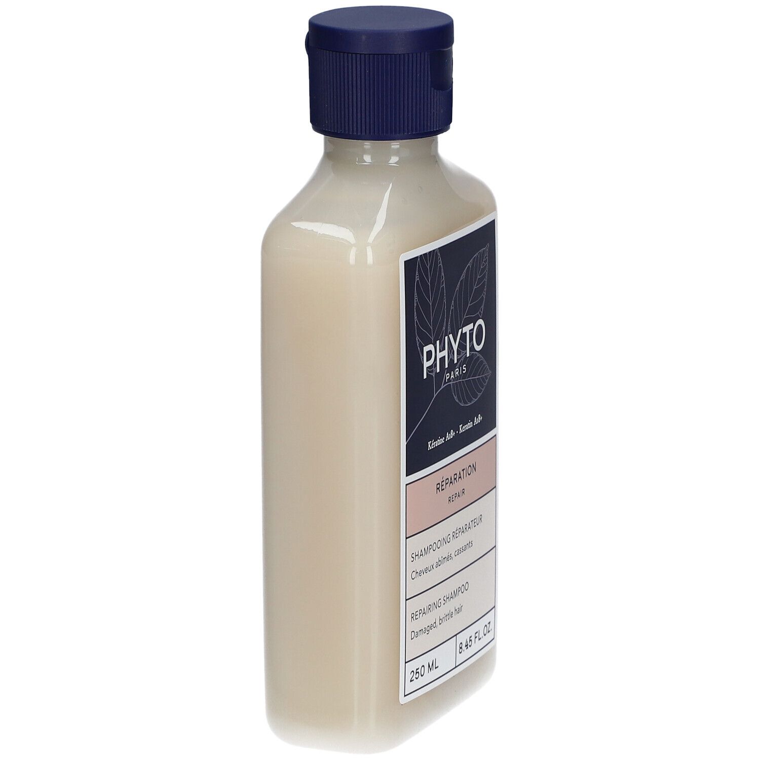 Fles PHYTO Repairing Shampoo, zijaanzicht. Blauw-wit etiket. 250 ml. Blauwe dop.