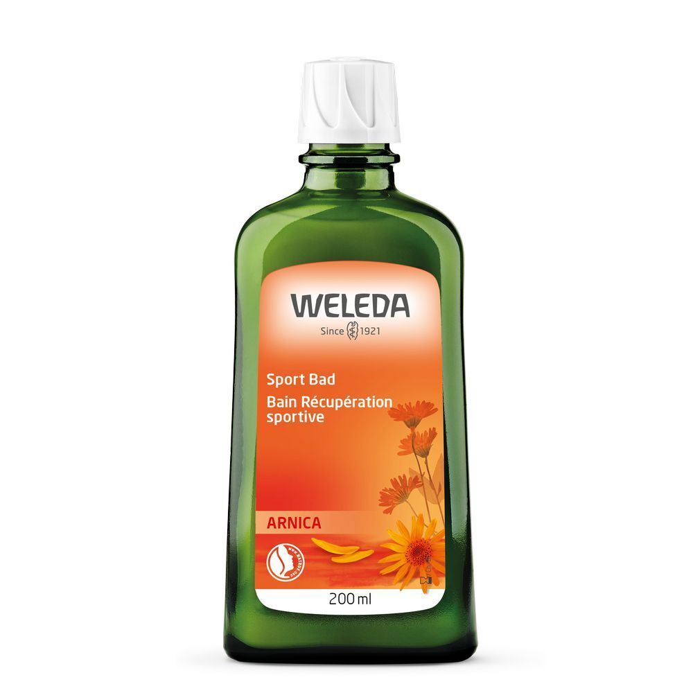 Grüne Glasflasche mit weißem Verschluss. Etikett mit Weleda-Logo, Produktname, Arnika-Blüten-Illustration und Volumenangabe.