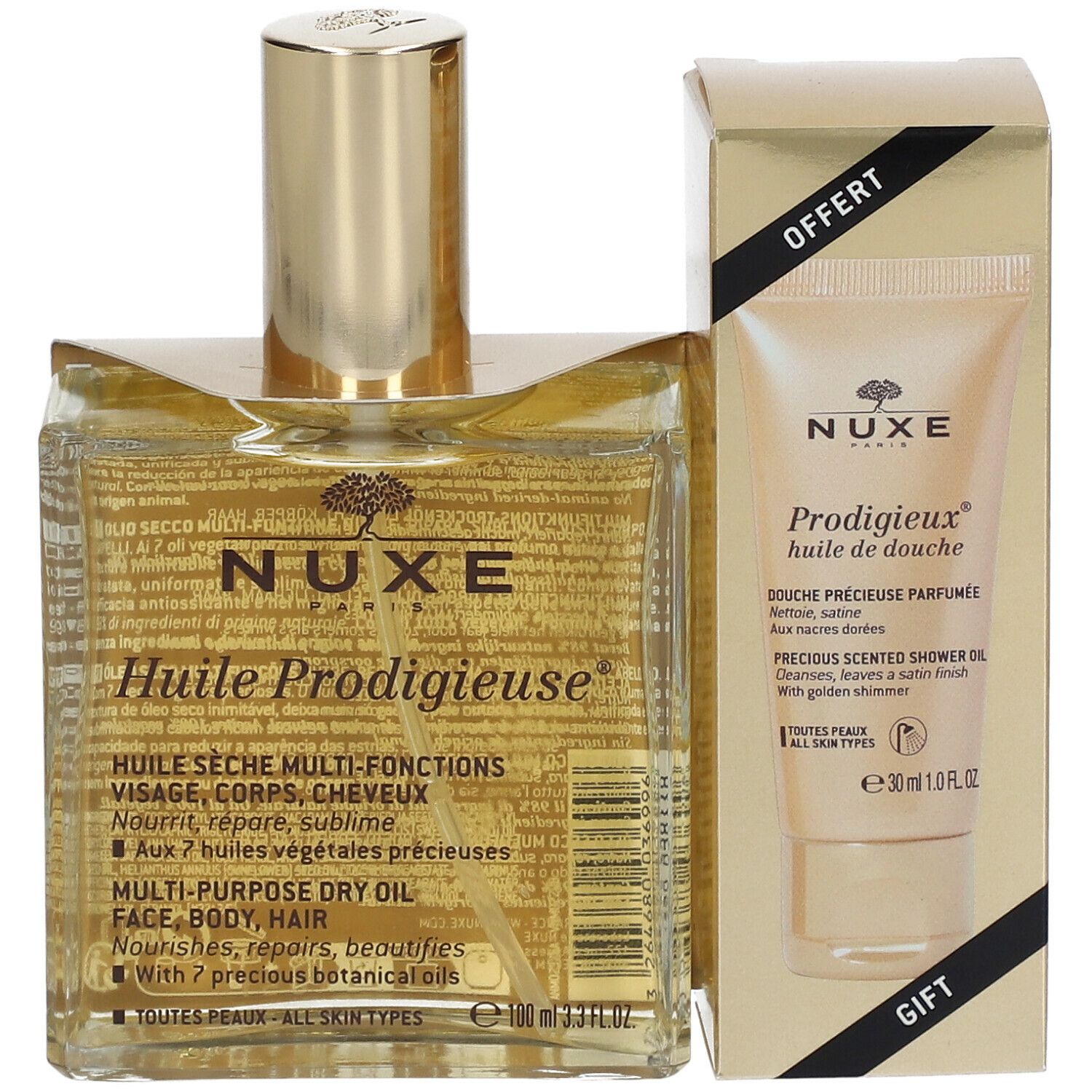 Flacon et tube dans un emballage doré. Inscription: Nuxe Huile Prodigieuse, Prodigieux huile de douche. Cadeau.