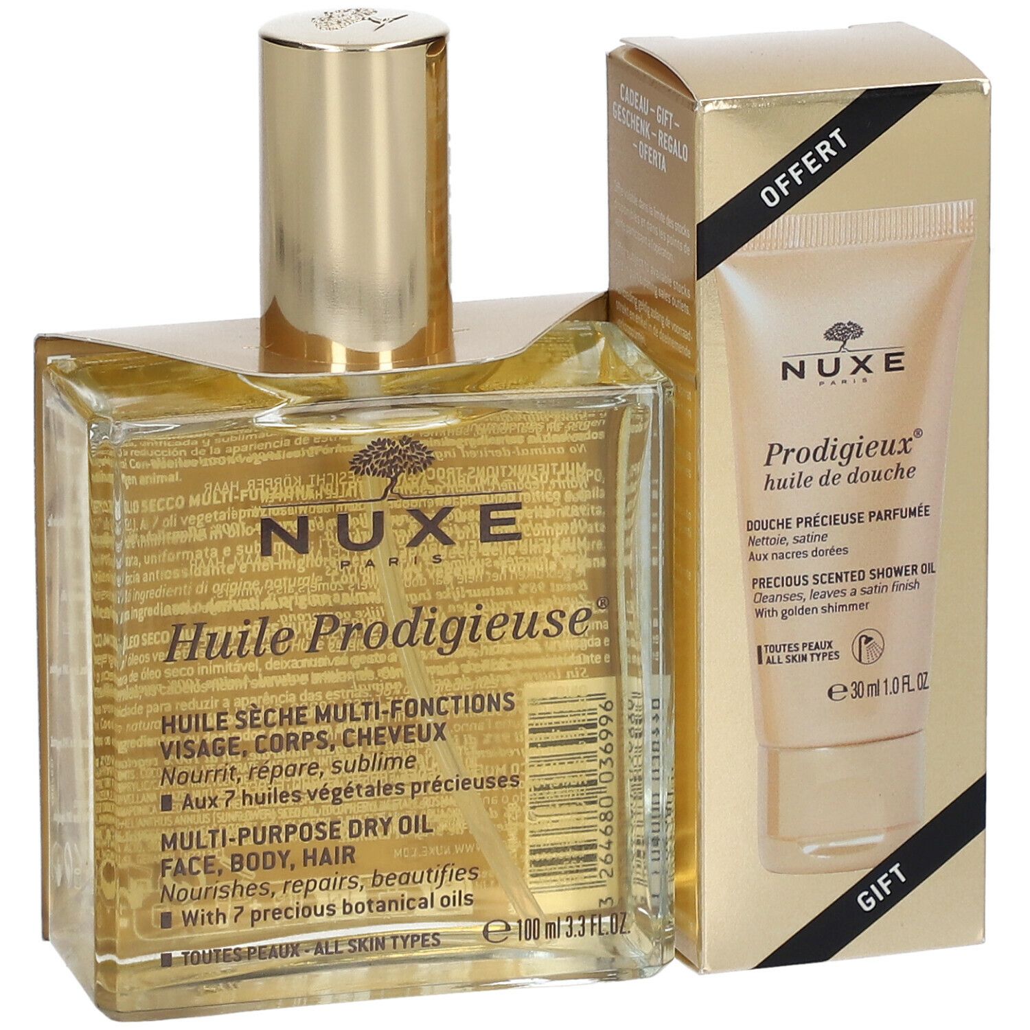 Flacon et tube dans un emballage doré. Inscription: Nuxe Huile Prodigieuse, Prodigieux huile de douche. Cadeau.