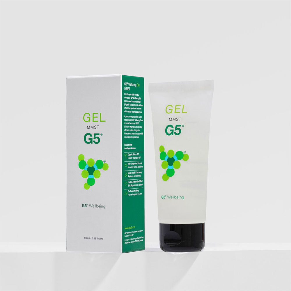 Witte tube en verpakking. Opschrift: GEL MMST G5 Wellbeing. Zwarte dop. Groene en witte kleurencombinatie.