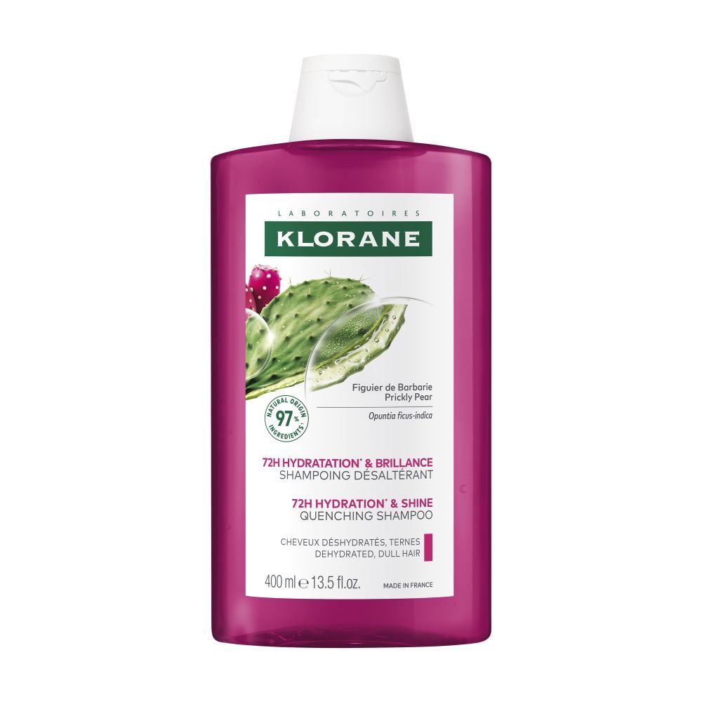 Flacon de shampooing Klorane. Liquide rose, bouchon blanc. Étiquette avec figue de Barbarie et texte.