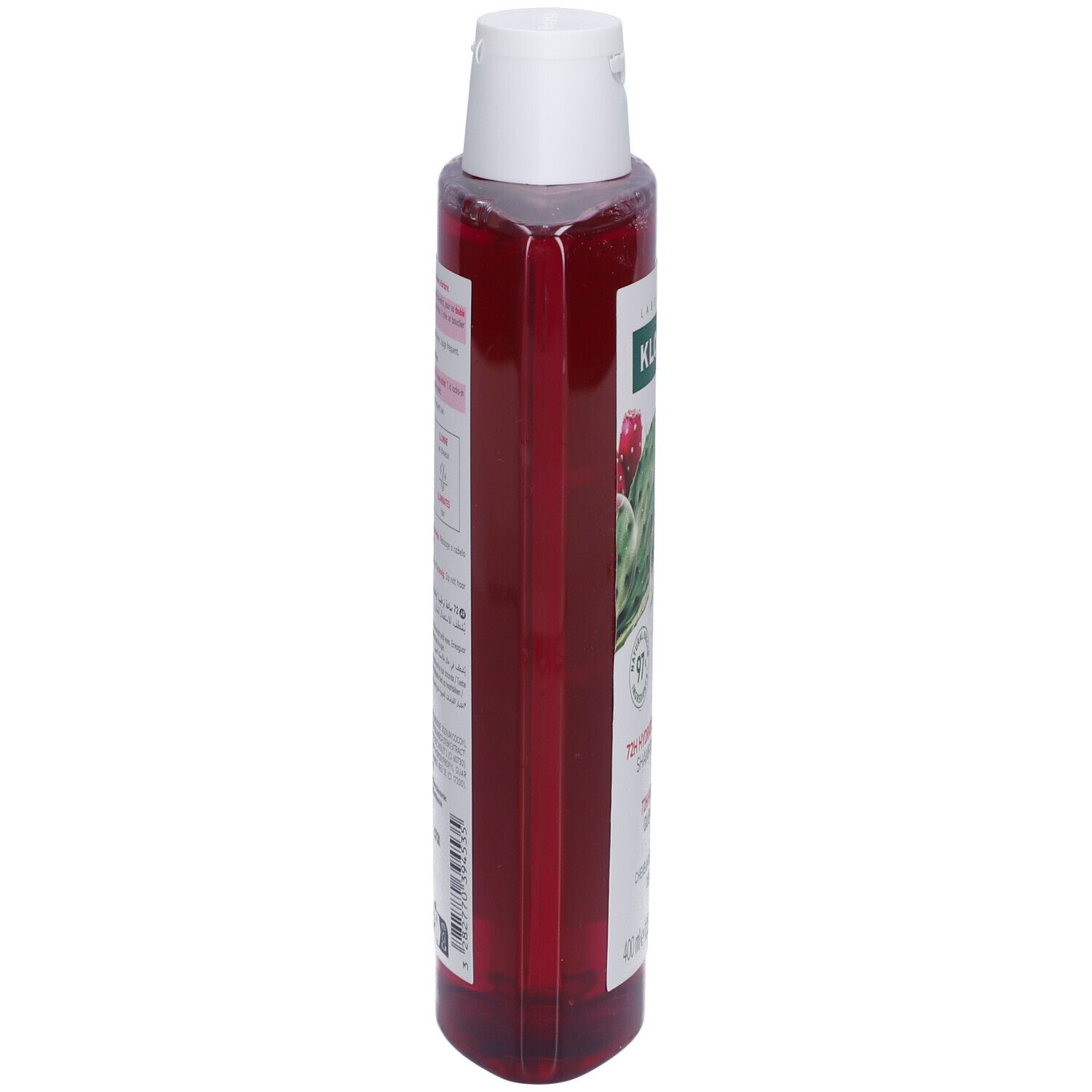 Flacon de shampooing Klorane, vue latérale. Liquide rose, bouchon blanc. Étiquette visible.