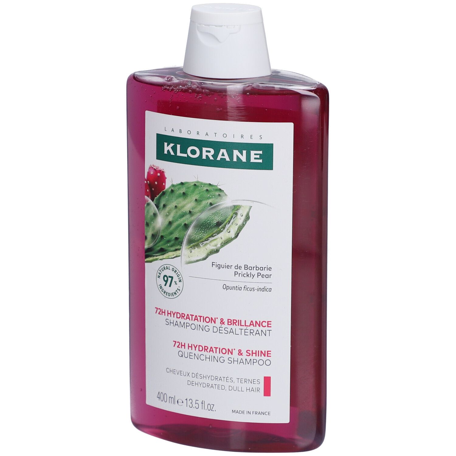 Flacon de shampooing Klorane. Liquide rose, bouchon blanc. Étiquette avec figue de Barbarie et texte.