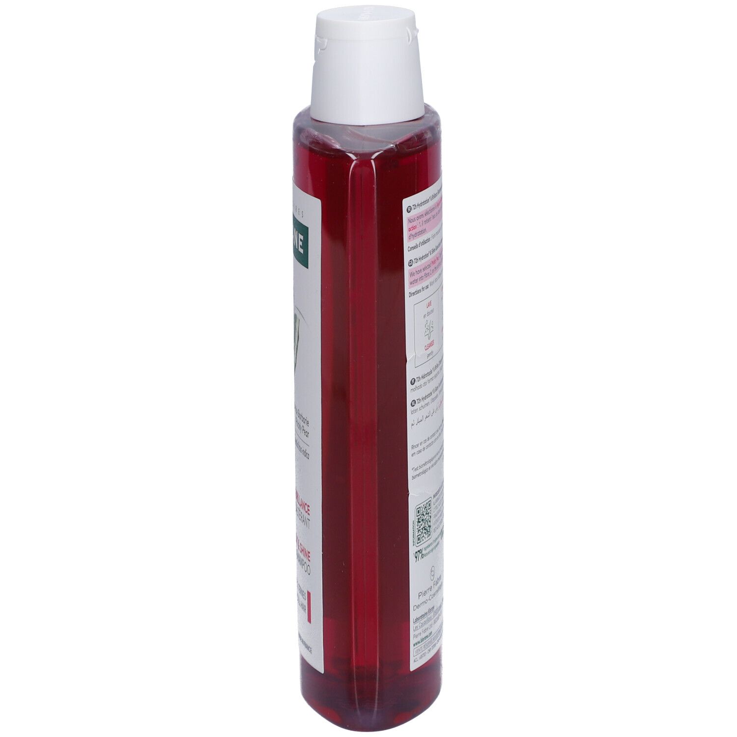 Flacon de shampooing Klorane, vue latérale. Liquide rose, bouchon blanc. Étiquette visible.