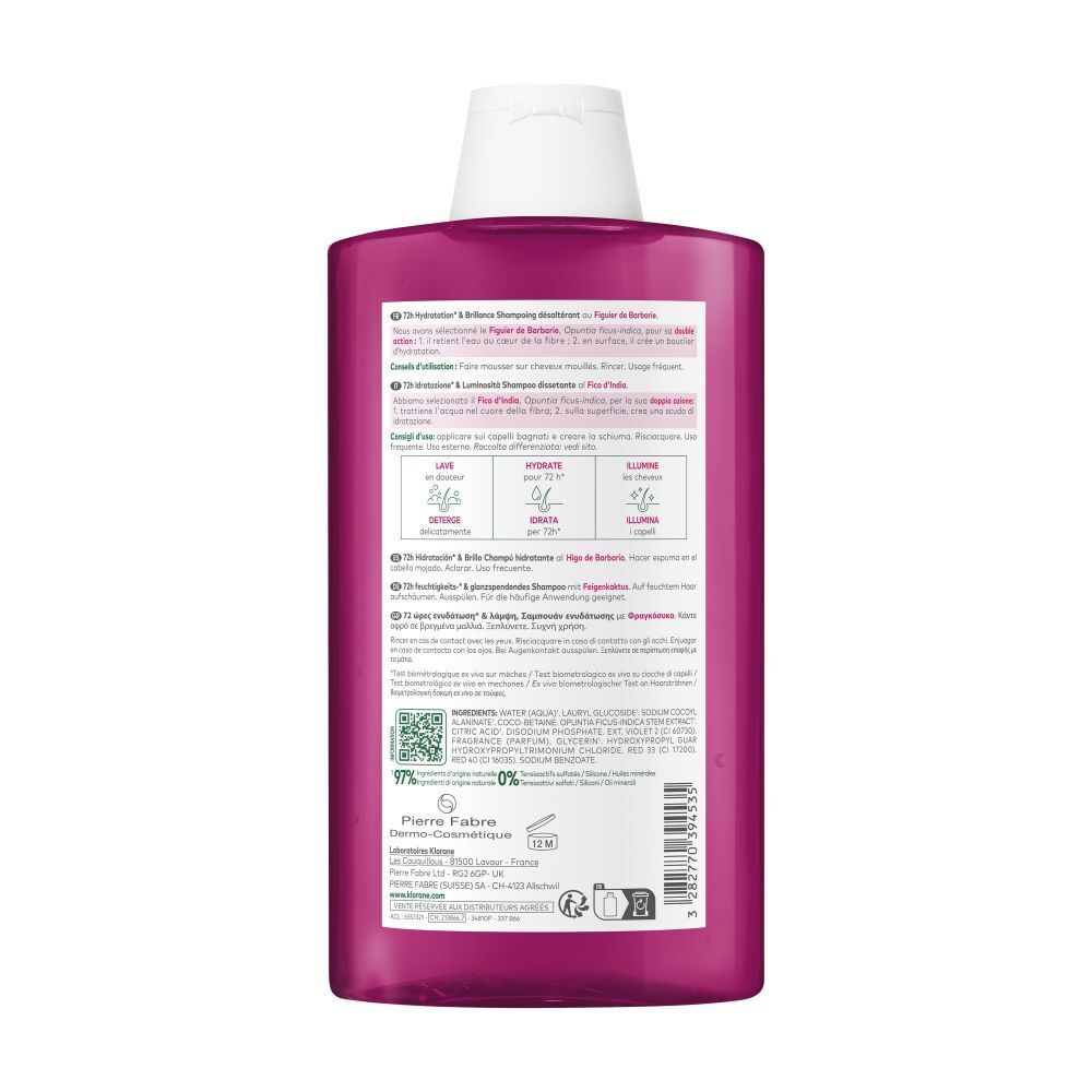 Dos du flacon de shampooing Klorane. Liquide rose, bouchon blanc. Texte et étiquette.