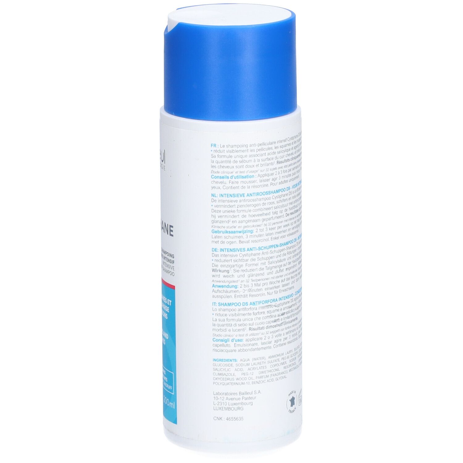 Dos du flacon de shampooing blanc avec bouchon bleu. Texte multilingue. Code-barres et informations fabricant.