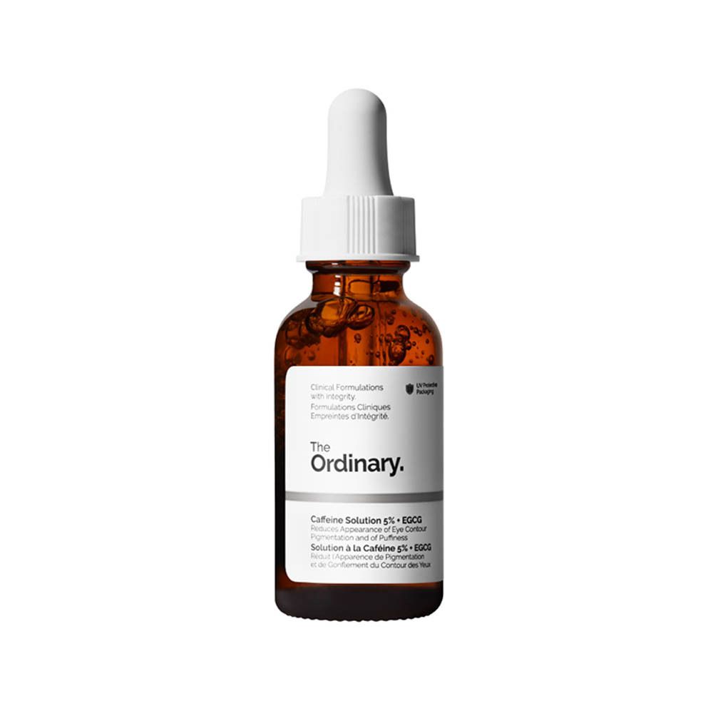 Bruine glazen fles met pipet. Opschrift: The Ordinary. Productnaam en beschrijving op het etiket.