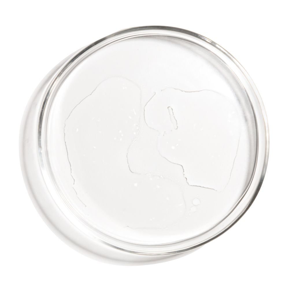 Flacon transparent contenant un liquide clair. Étiquette blanche. Bouchon blanc.
