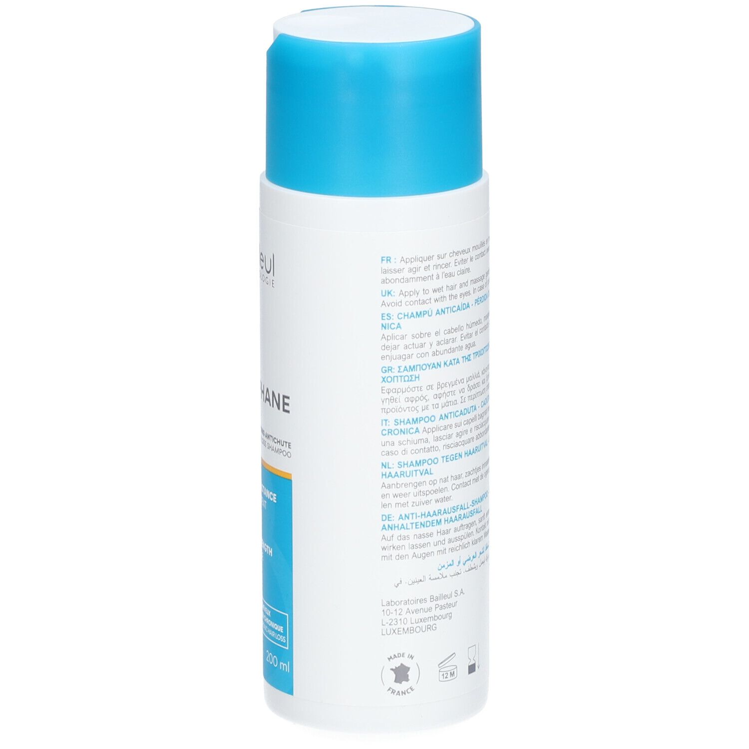 Flacon blanc avec bouchon bleu. Inscription: Cystiphane, Shampooing Antichute. Texte multilingue.