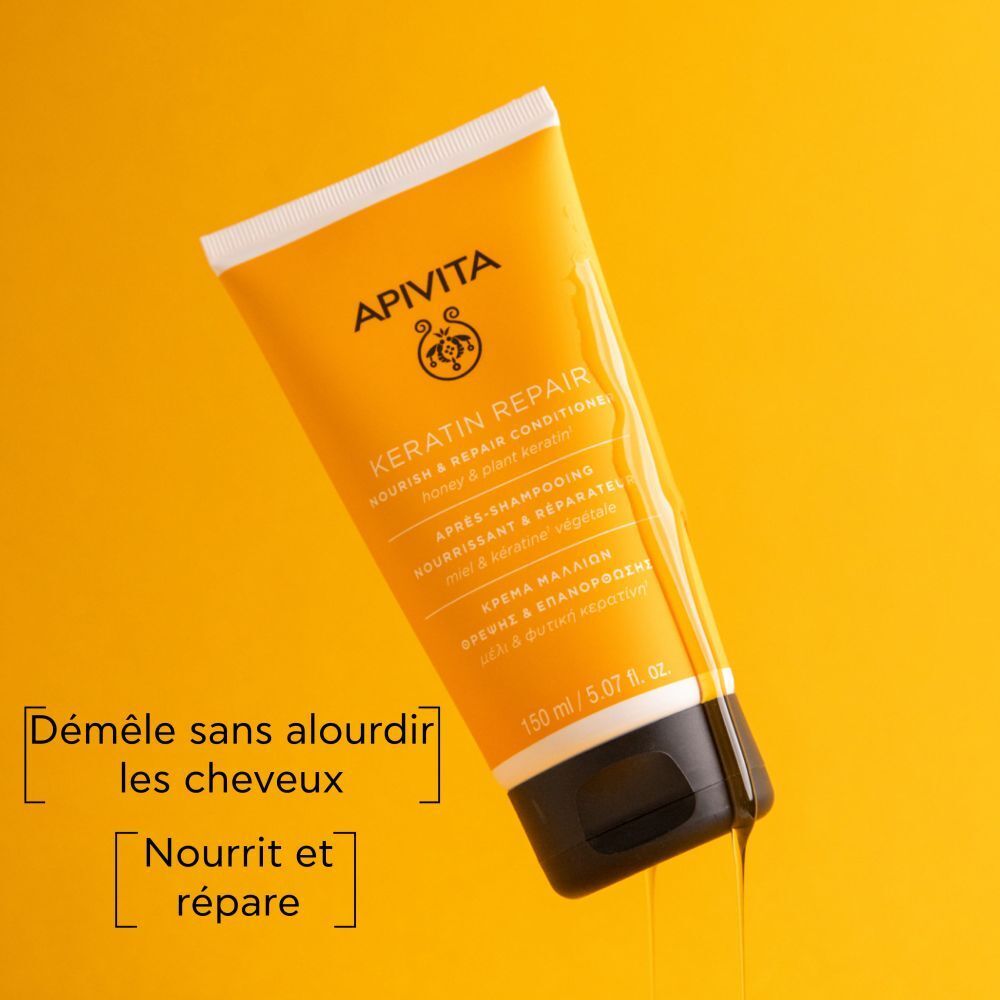 Tube jaune, bouchon noir. Texte: Apivita, Keratin Repair Conditioner. Sur fond jaune.