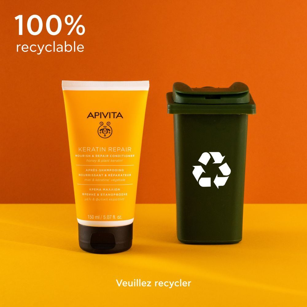 Tube jaune, bouchon noir. Texte: Apivita, Keratin Repair Conditioner. Avec symbole de recyclage.