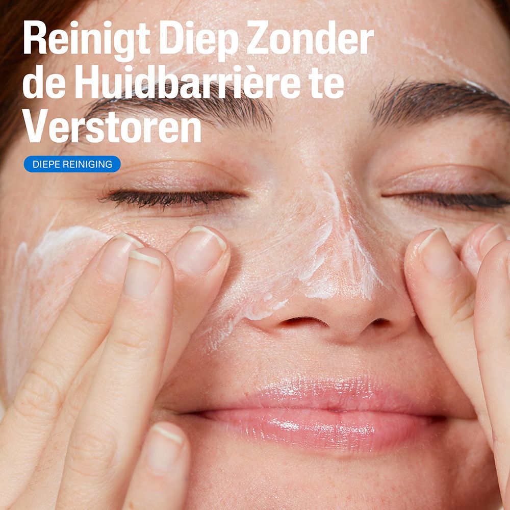 Vrouw wast gezicht met witte reiniger. Tekst: Reinigt diep zonder de huidbarrière te verstoren.