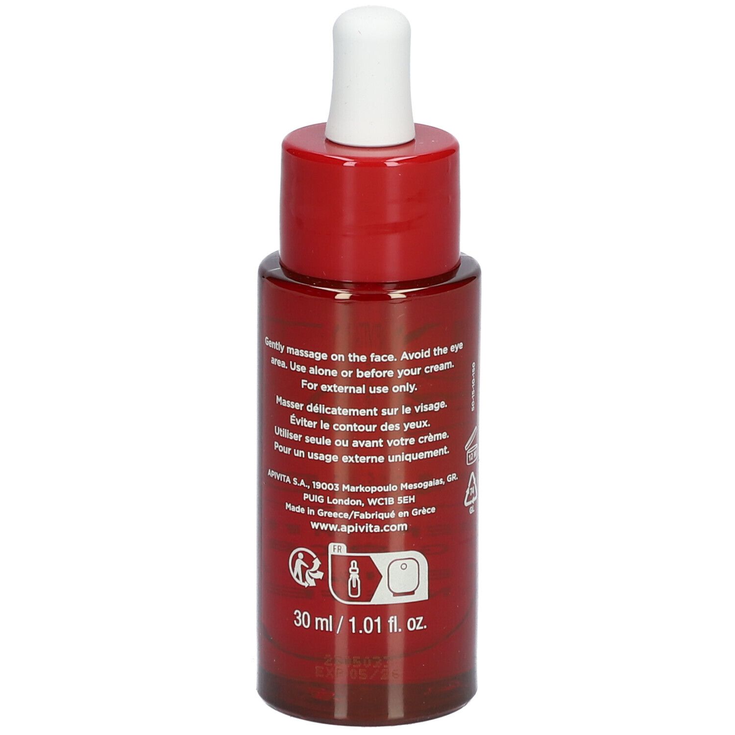 Flacon rouge avec compte-gouttes blanc. Inscription: APIVITA BEEVINE ELIXIR. Huile visage.