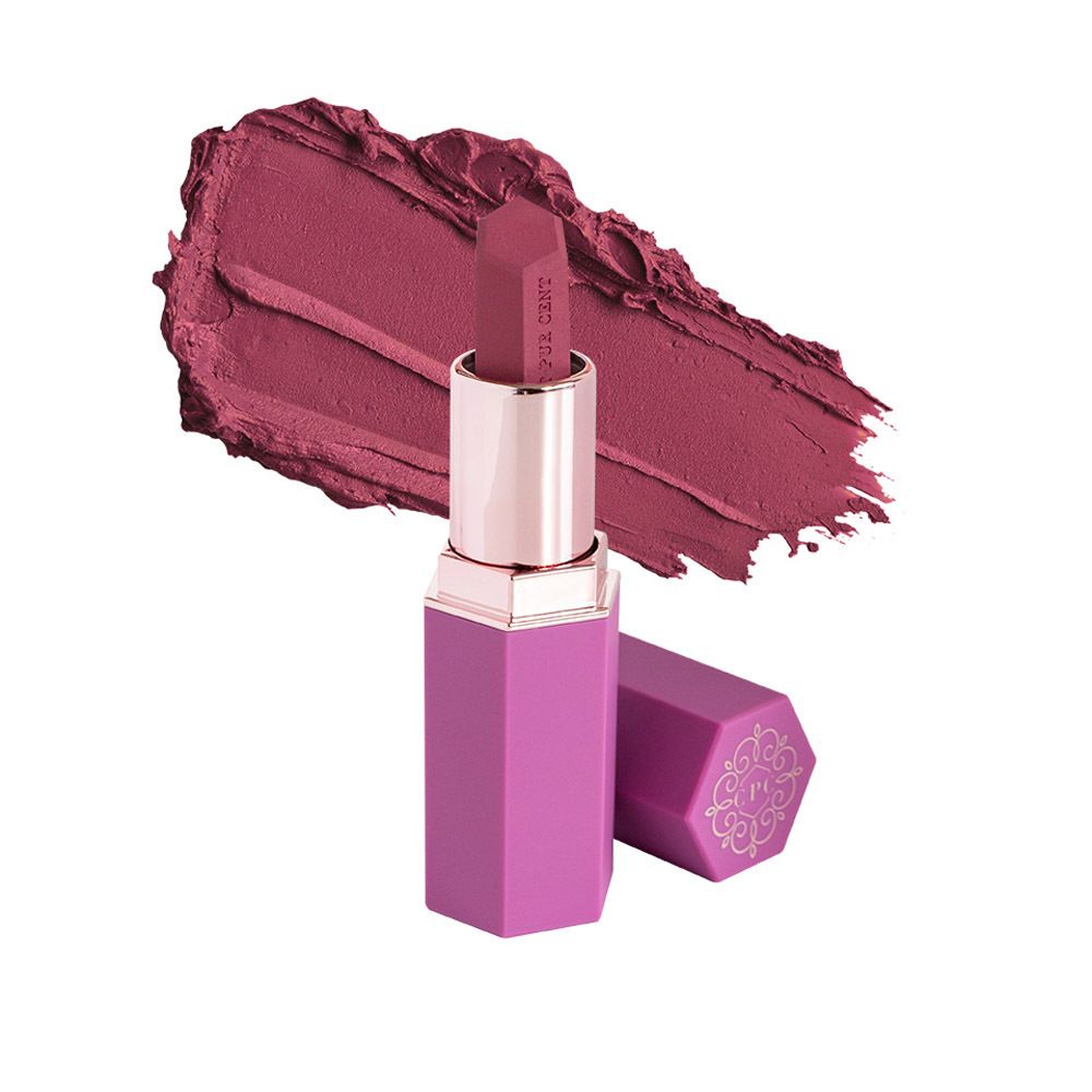Rouge à lèvres avec étui rose et bague dorée. À côté, une trace de rouge à lèvres.