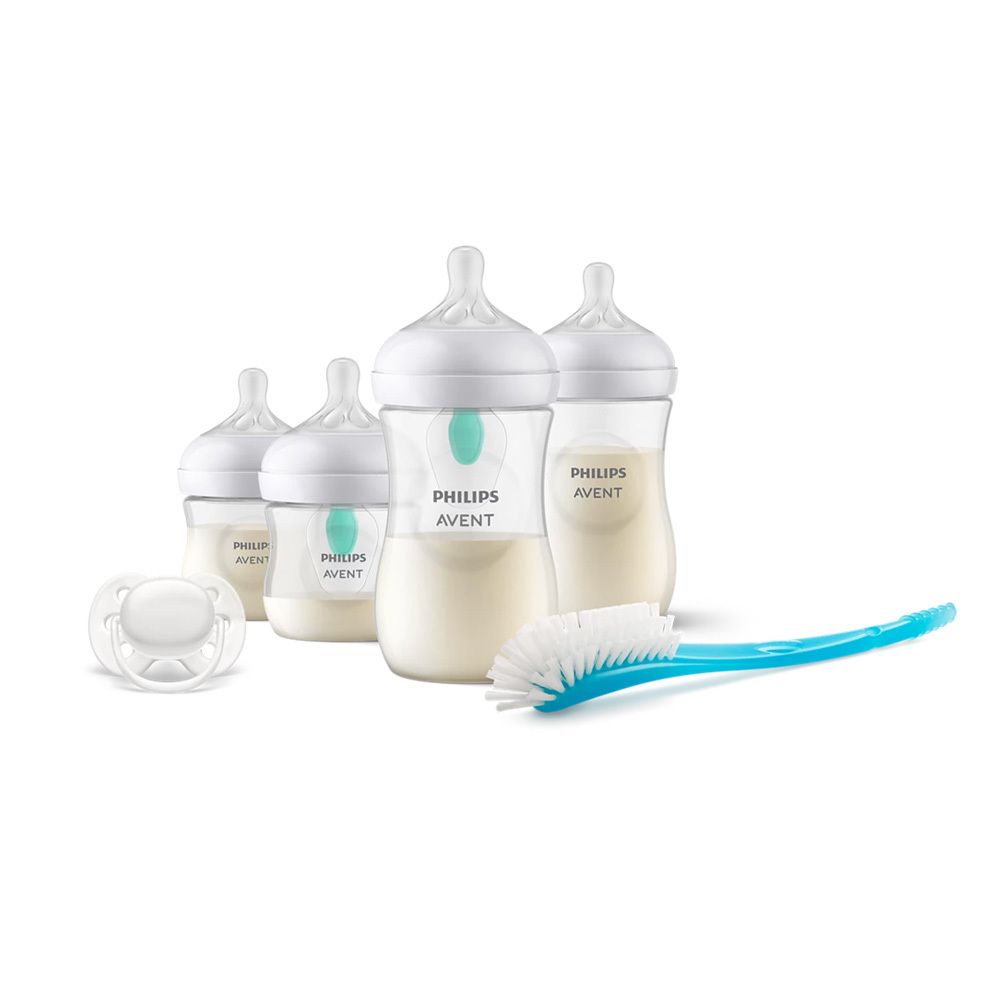 PHILIPS AVENT-Flaschen-Set. Enthält Flaschen, Schnuller und Bürste. Flaschen mit Milch gefüllt.