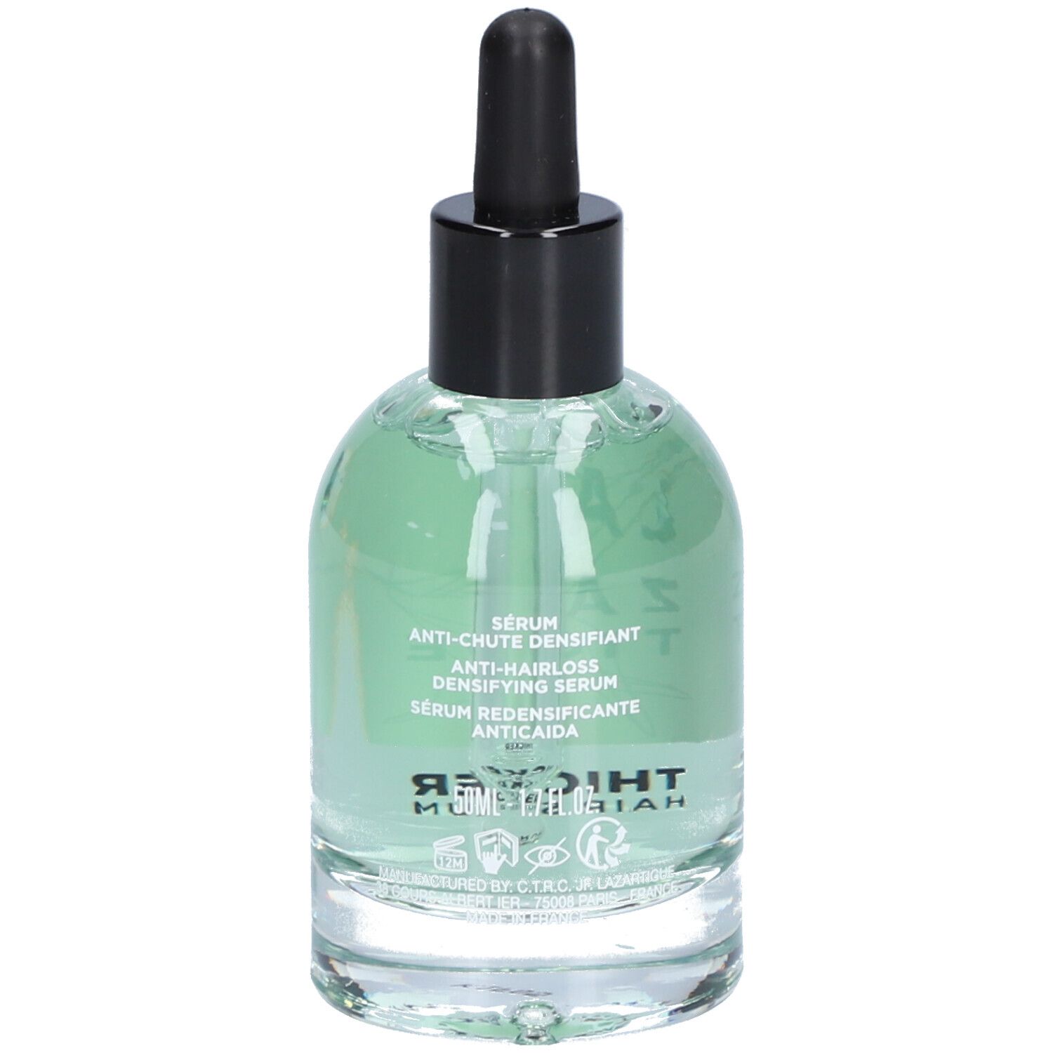 Glazen fles met groenachtig serum, zwarte dop en pipet. Op het etiket staat "Thicker Hair Serum" en andere teksten.