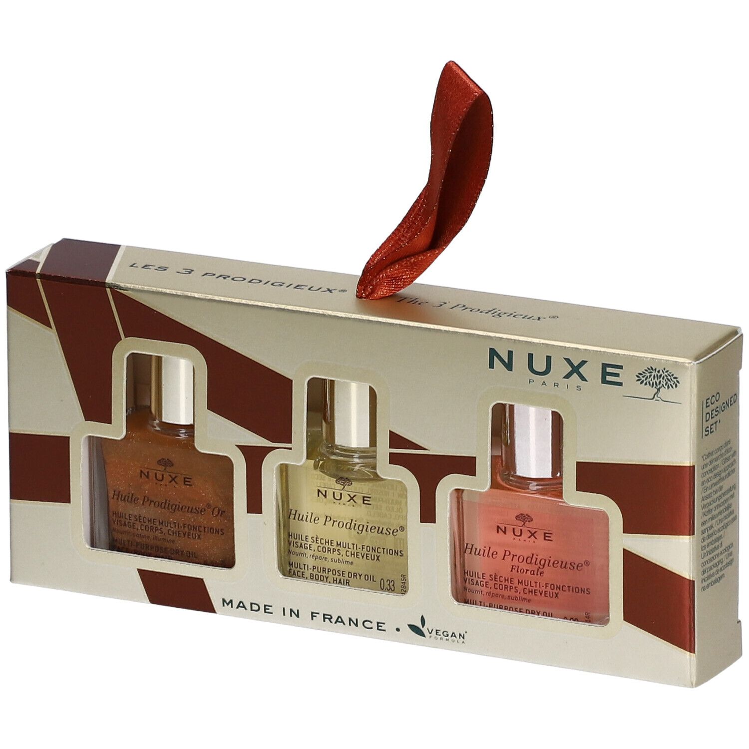 Coffret cadeau avec trois flacons d'huile. Logo Nuxe, nom du produit, label vegan. Ruban rouge pour suspendre.
